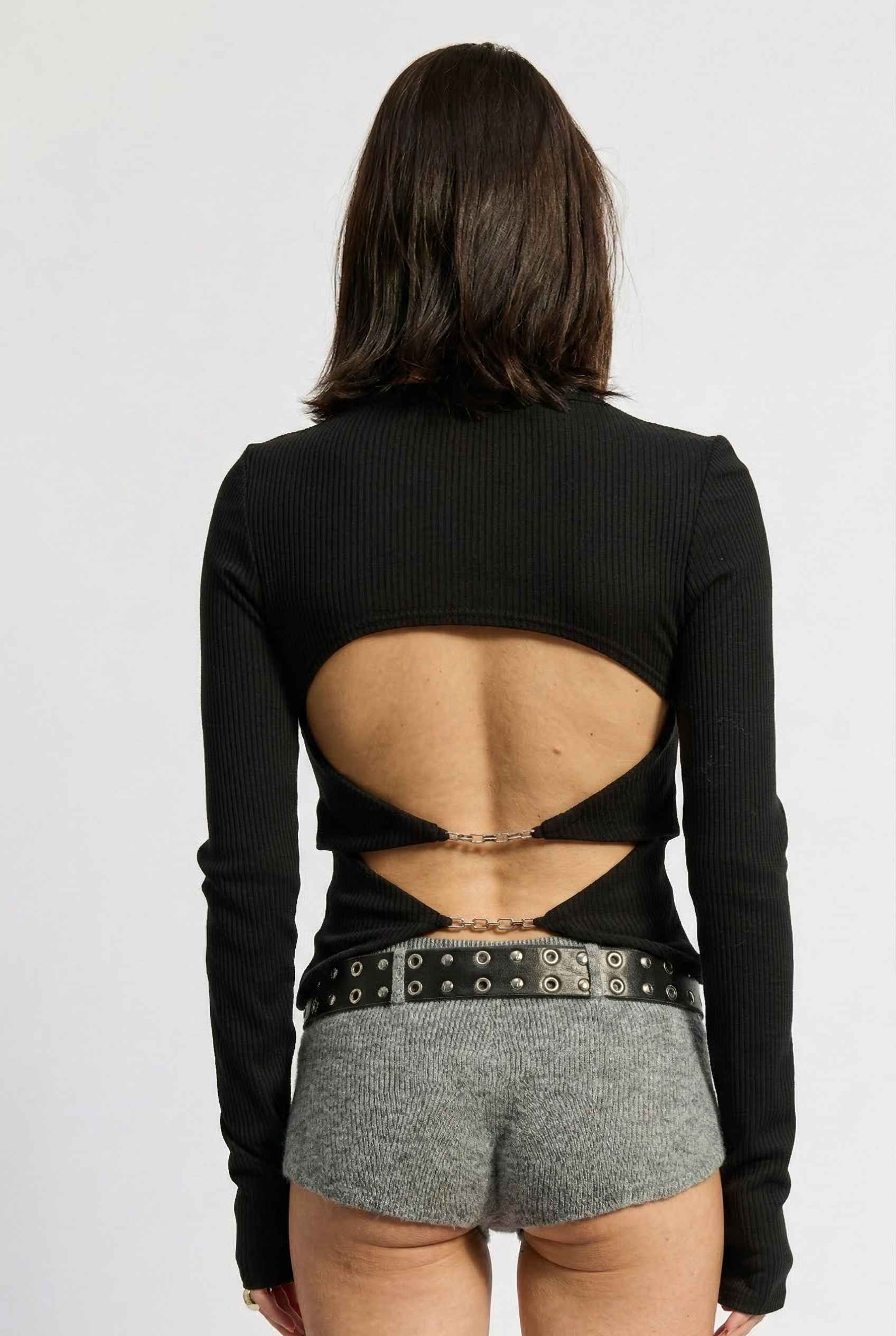Model wearing Sloane Top in Black Cotton-Rayon Ribbed Crew Neck Long Sleeve Tee with knit shorts and belt