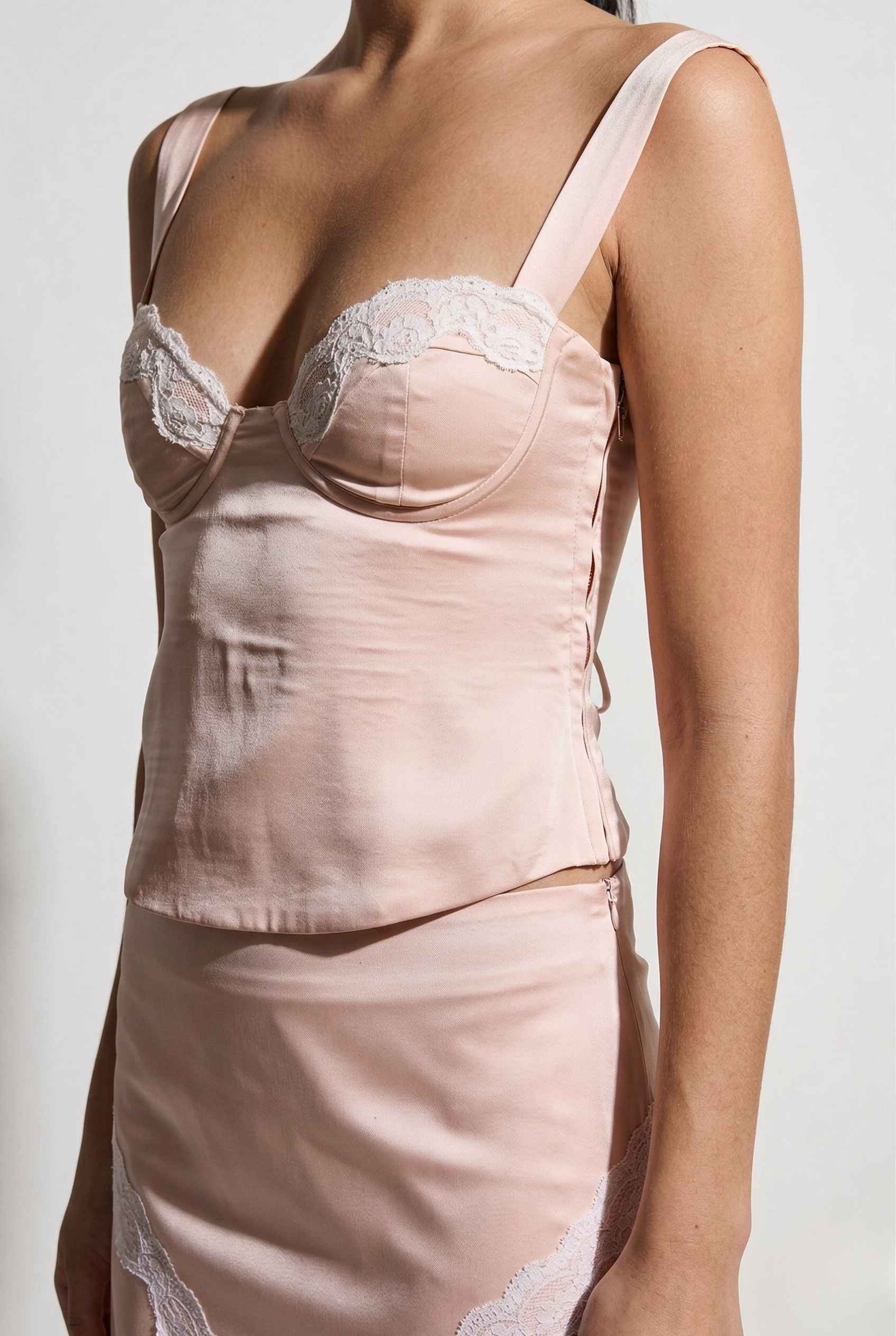 Sophie Top Pink Pastel Satin Corset Cami with White Lace Trim with lace details on a plain background