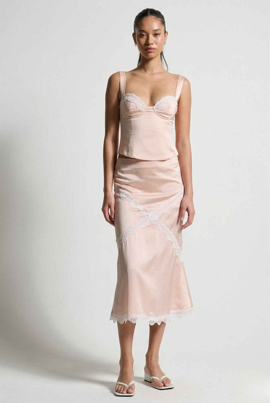 Woman wearing a Sophie Top Pink Pastel Satin Corset Cami with White Lace Trim with lace details on a white background