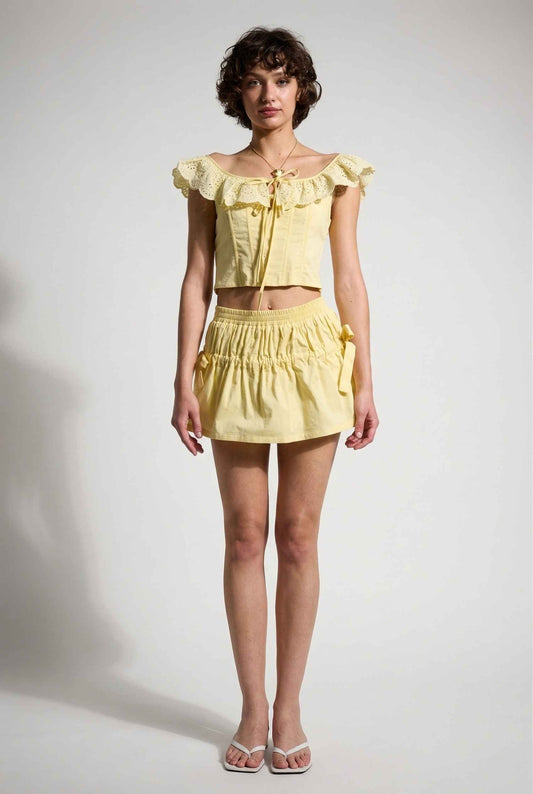 Sunnie Skirt in Soft Yellow Poplin Mini Skirt with Bows paired with matching ruffle top and slip-on sandals