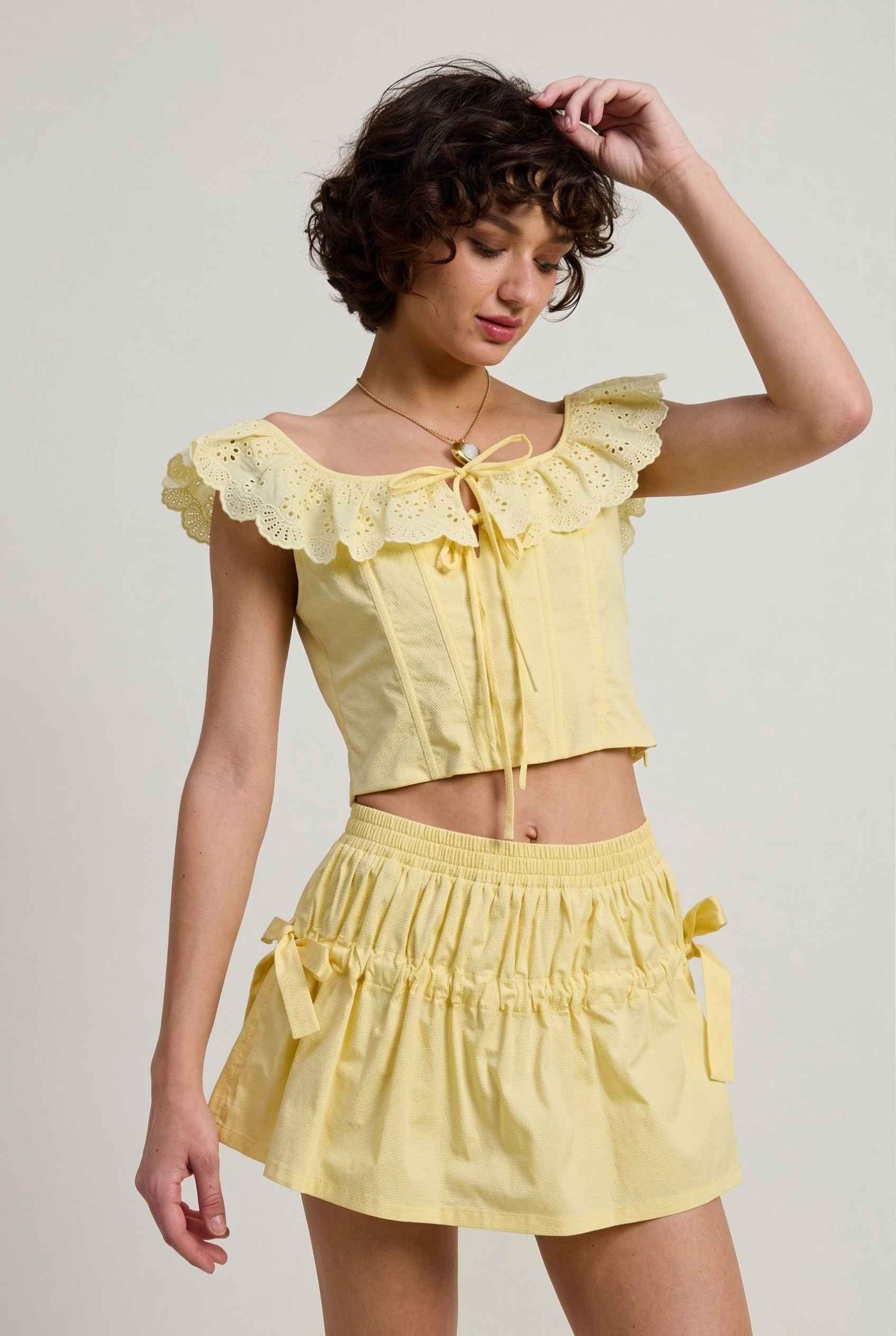 Sunnie Skirt in Soft Yellow Poplin Mini Skirt with Bows paired with matching ruffle top close bow detail