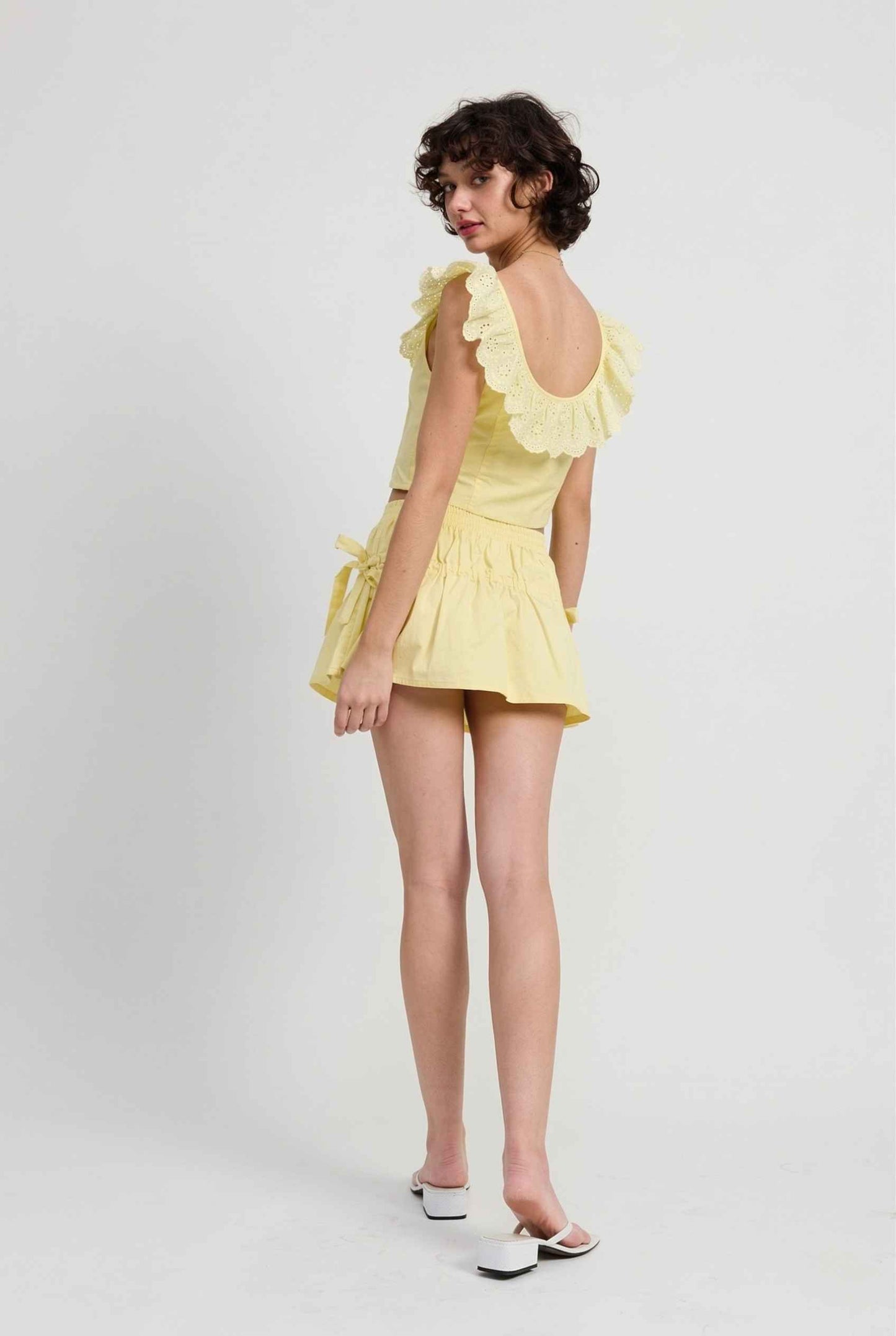 Sunnie Skirt in Soft Yellow Poplin Mini Skirt with Bows paired with matching ruffle top and slip-on sandals