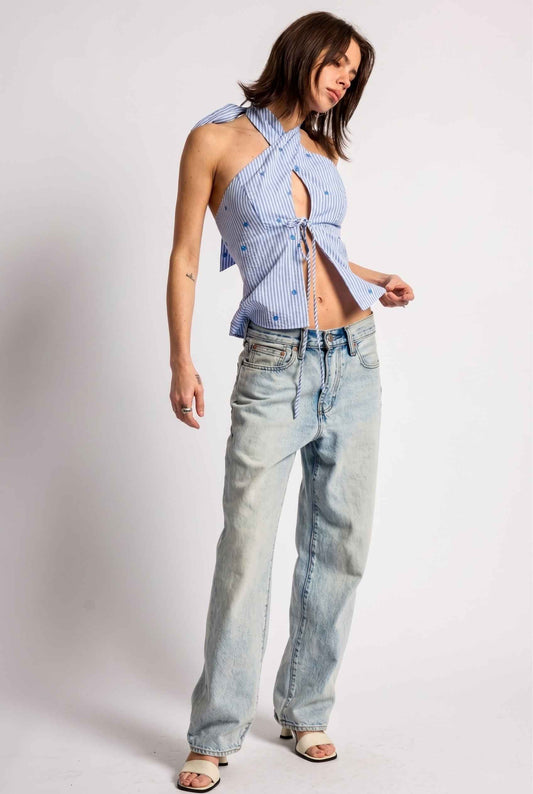 Model wearing Sara Cross-Neck Striped Cotton Halter Top Heart Embroidered Tank Top in Blue with jeans and heeled sandals