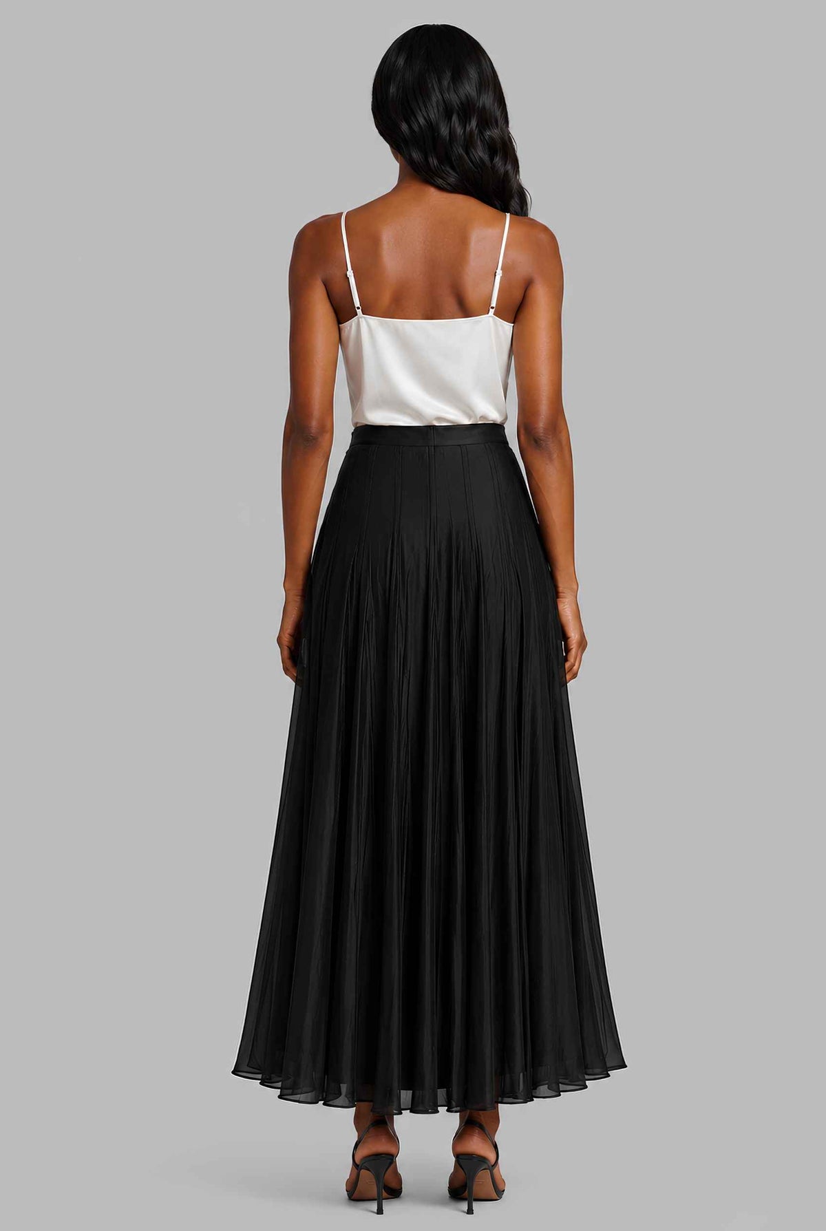 Virtual model wearing The Astrid Pleated Skirt Lustrous Satin Pleated Skirt in Black
