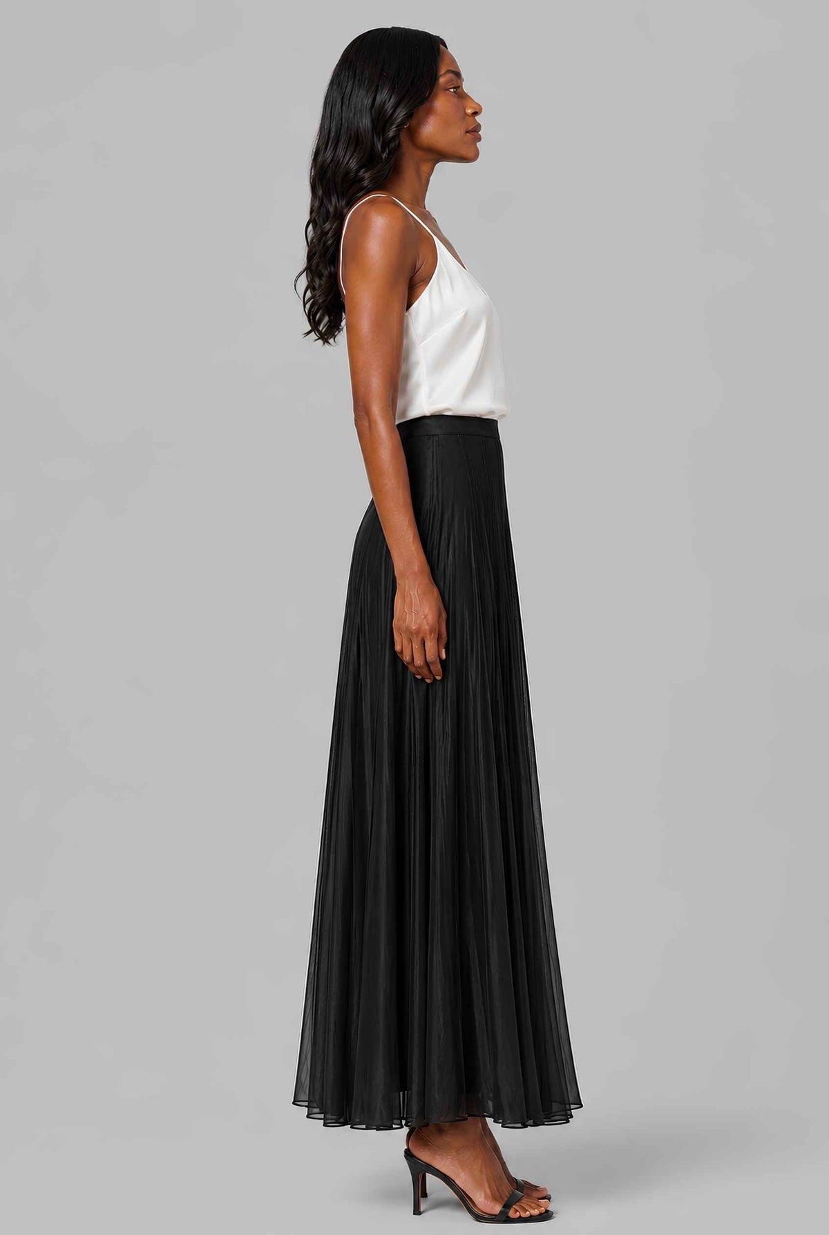 Virtual model wearing The Astrid Pleated Skirt Lustrous Satin Pleated Skirt in Black