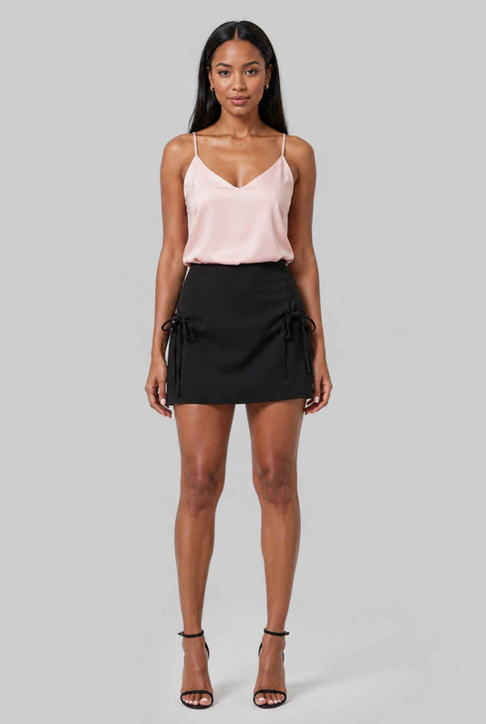 Virtual model wearing The Beau Satin Mini Skirt Tied Bow Detail Satin Mini Skirt in Black