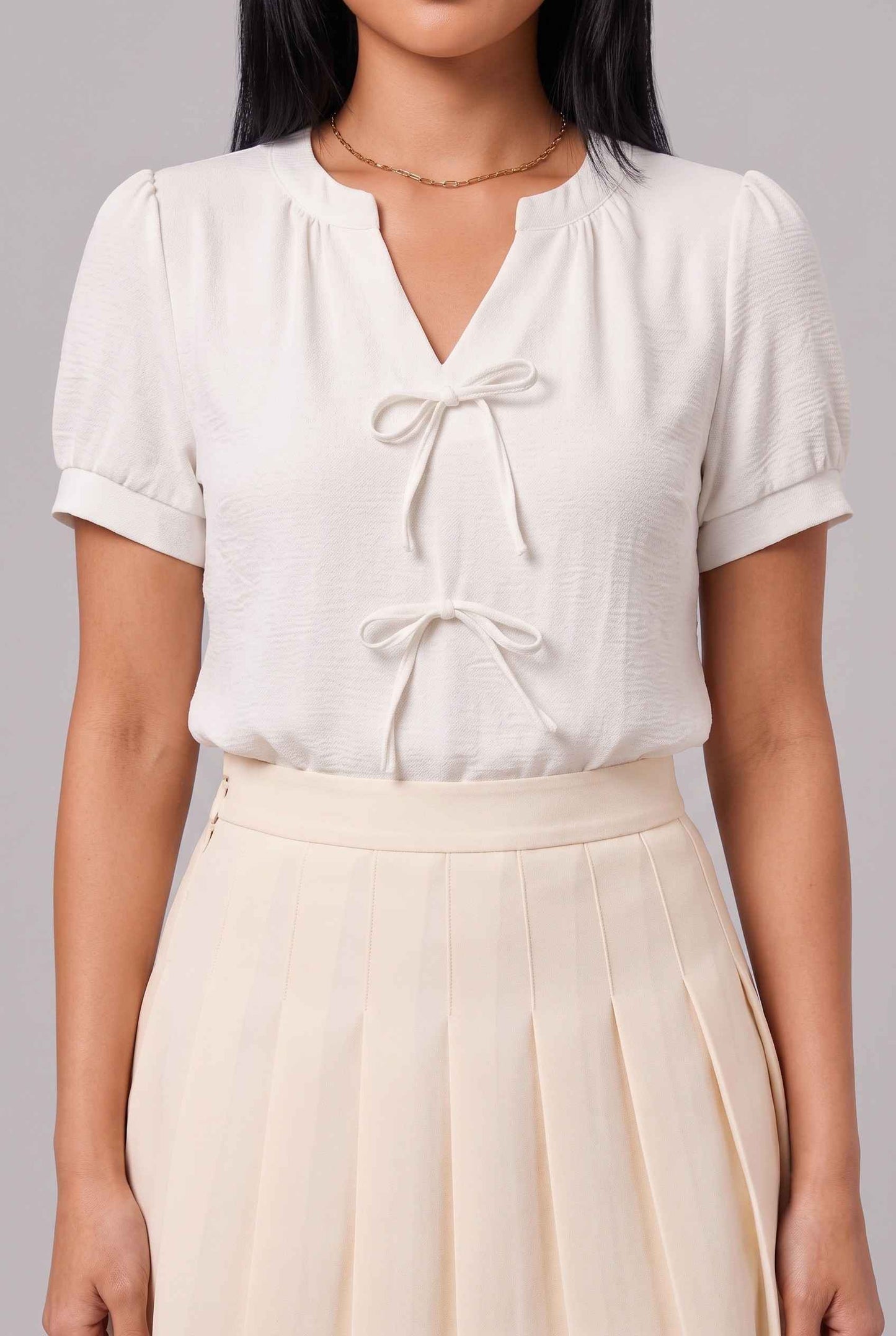 Virtual Model Wearing The Blythe Pleated Mini Skirt Cream High-Waisted Pleated Tennis Mini Skirt