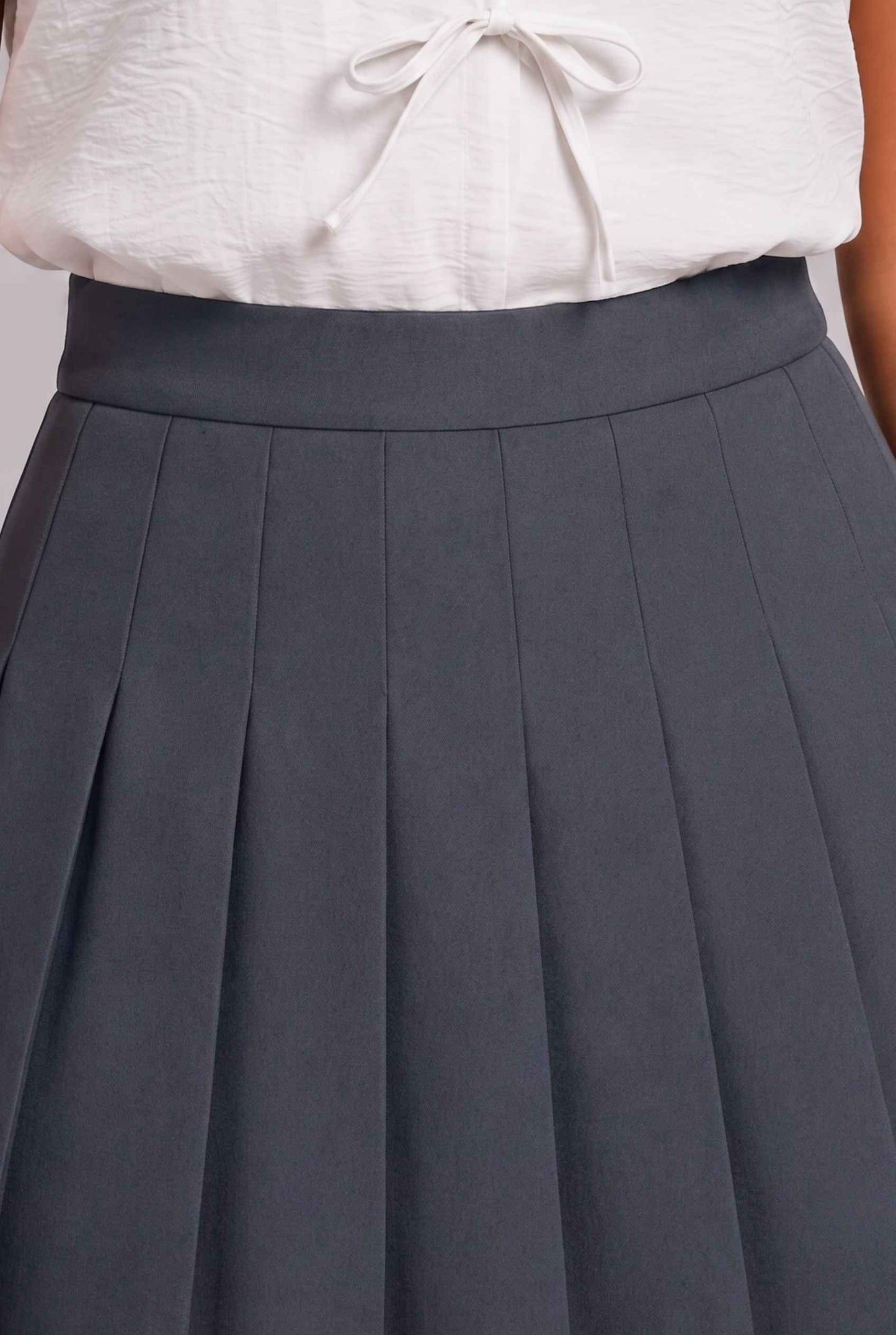 Virtual Model Wearing The Blythe Pleated Mini Skirt Gunmetal High-Waisted Pleated Tennis Mini Skirt