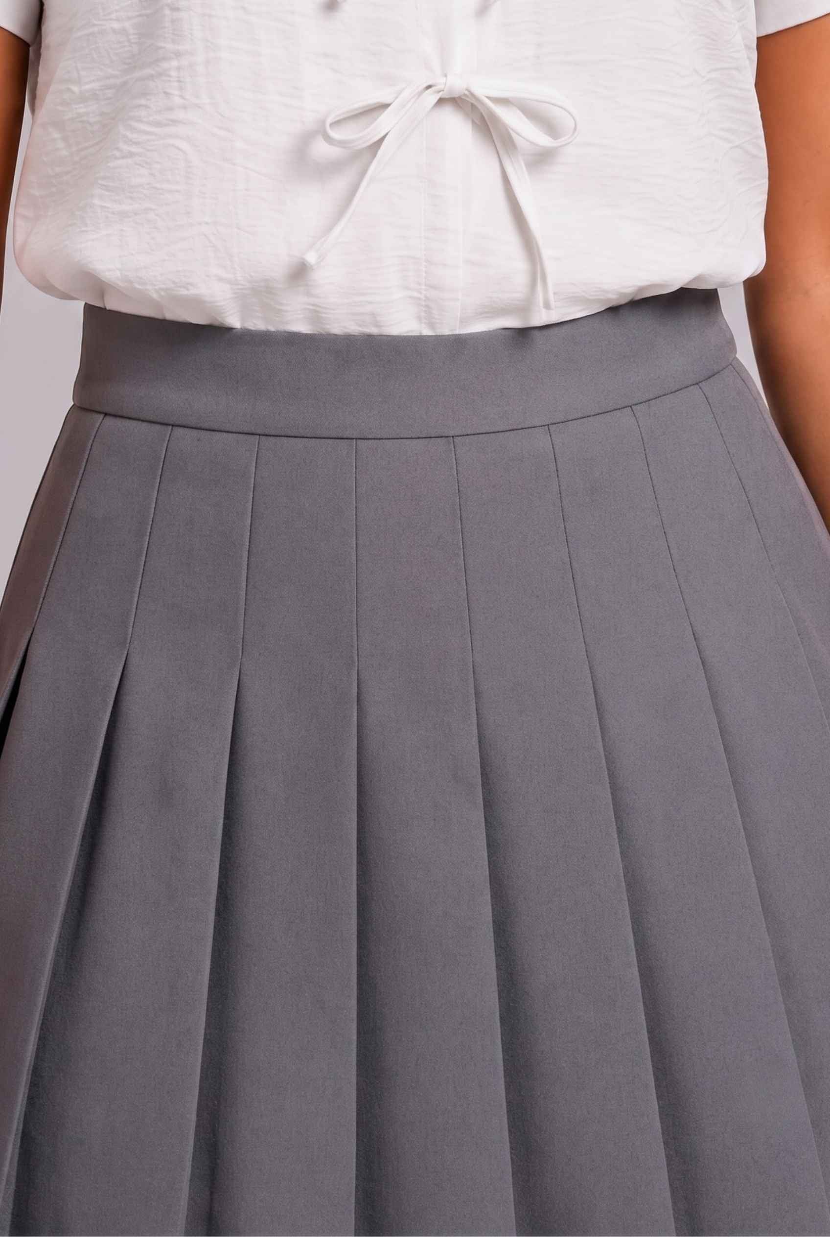 Virtual Model Wearing The Blythe Pleated Mini Skirt Light Gray High-Waisted Pleated Tennis Mini Skirt
