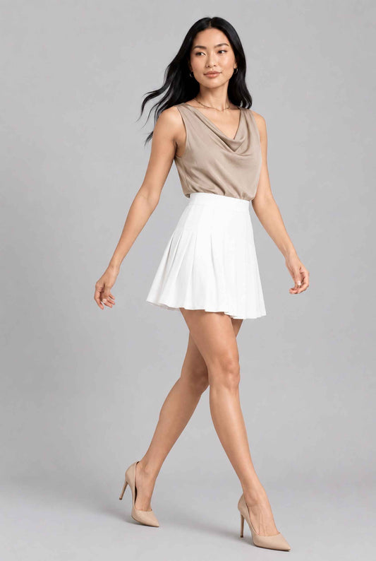 Virtual model wearing The Blythe Pleated Mini Skirt High-Waisted Pleated Tennis Mini Skirt in White