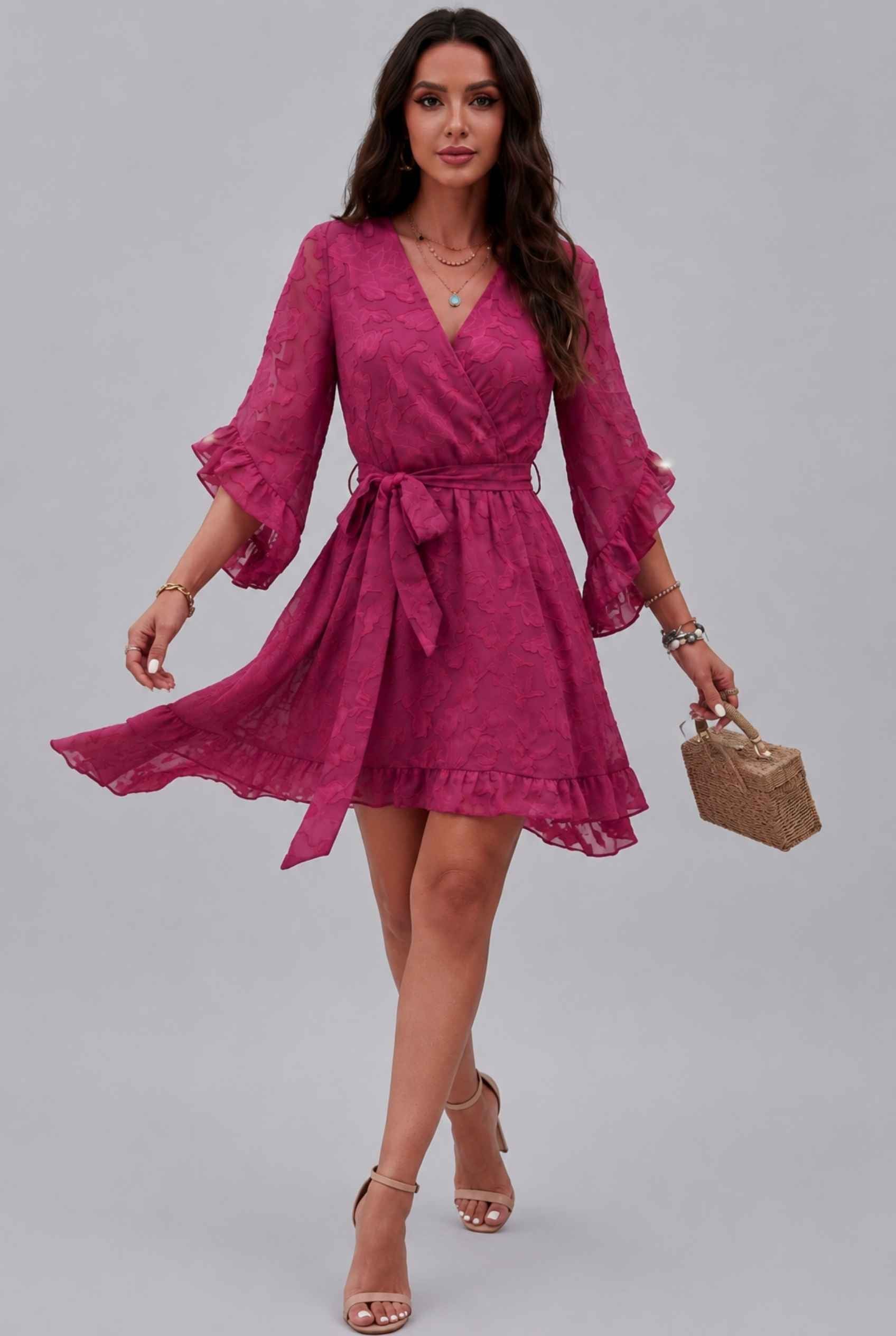 Woman wearing The Cherise Devoré Wrap Dress Jacquard Floral Lace Pink Mini Dresss on a gray background