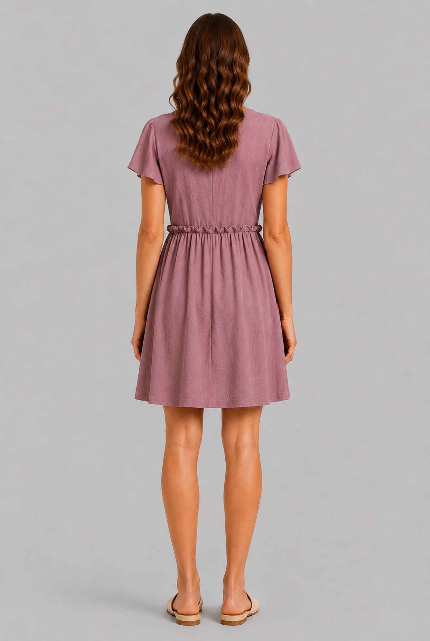 Virtual Model wearing The Delia Buttoned Mini Blush Flutter Sleeve Ruffled Dress
