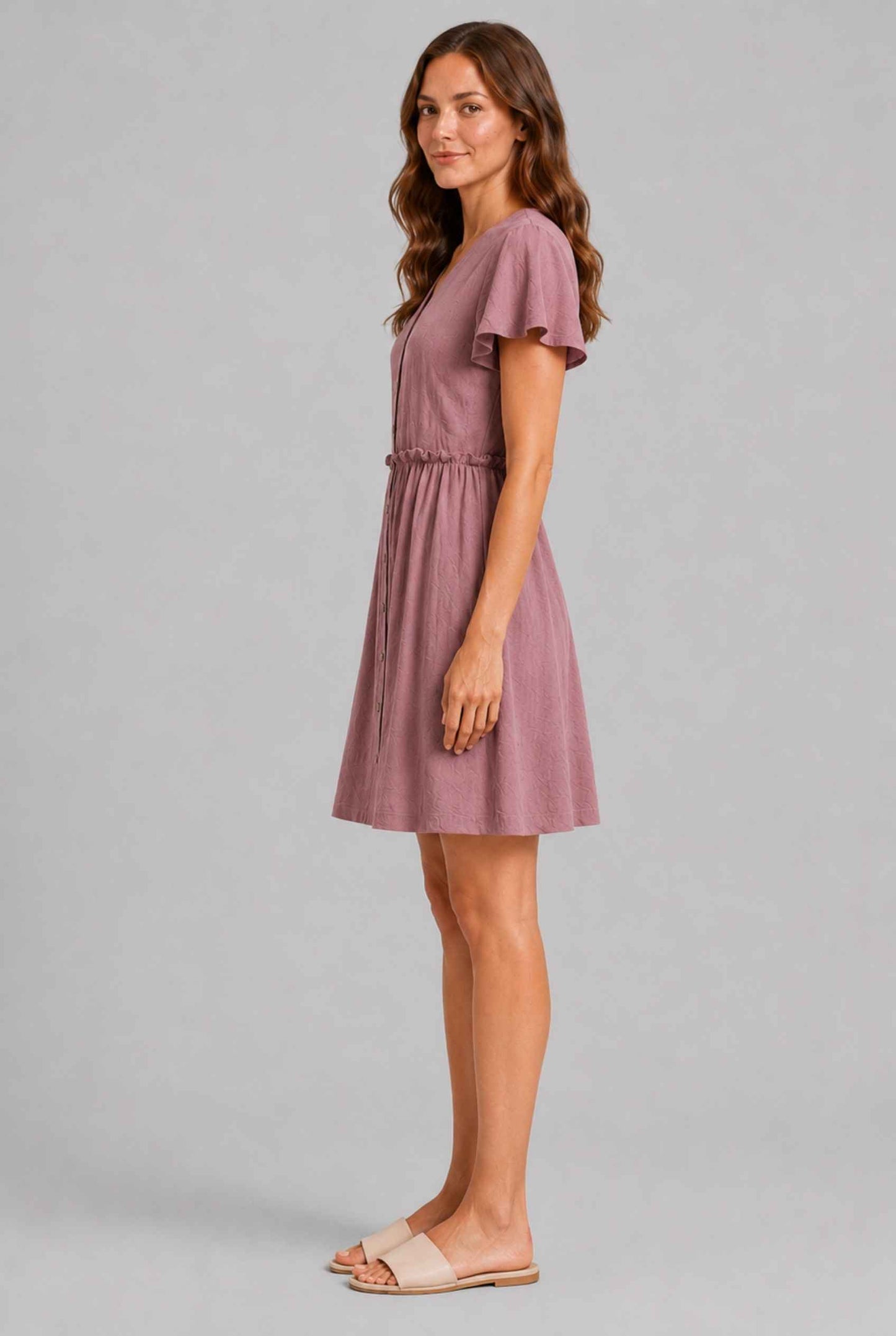 Virtual Model wearing The Delia Buttoned Mini Blush Flutter Sleeve Ruffled Dress