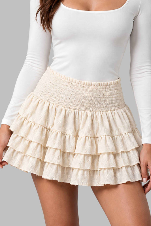 Virtual model wearing The Etta Tiered Ruffle Mini Skirt Smocked Ruffle Layered Mini Skirt in Cream