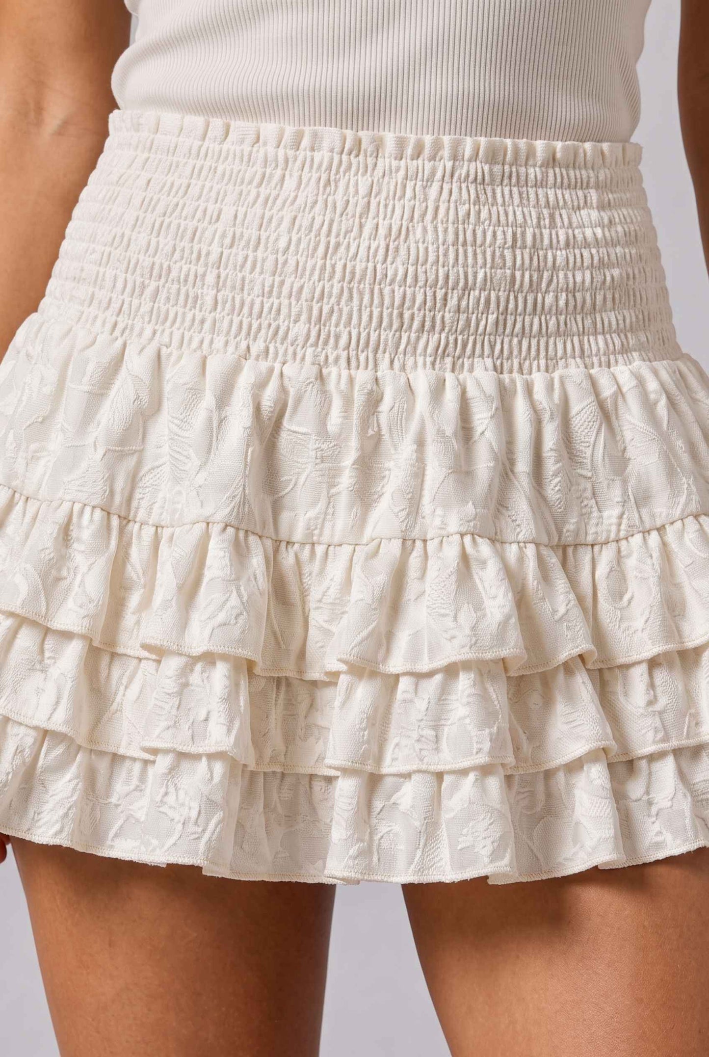 Virtual Model wearing The Etta Tiered Ruffle Mini Skirt Cream Smocked Ruffle Layered Mini Skirt