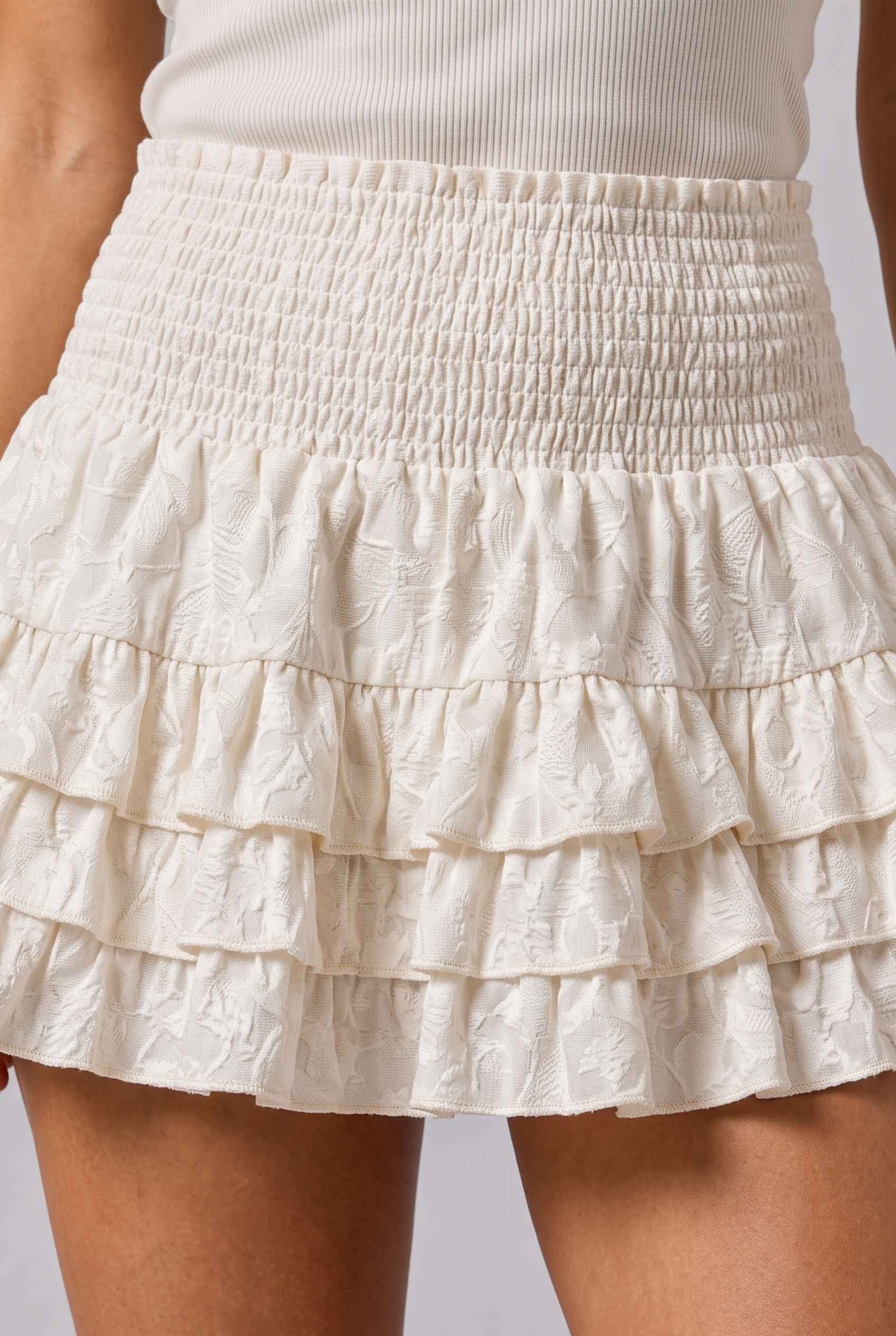 Virtual Model wearing The Etta Tiered Ruffle Mini Skirt Cream Smocked Ruffle Layered Mini Skirt