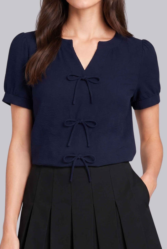 Virtual model wearing The Lillian Bow Blouse Puff Sleeve Bow Triple Detail Crepe Blouse in Navy