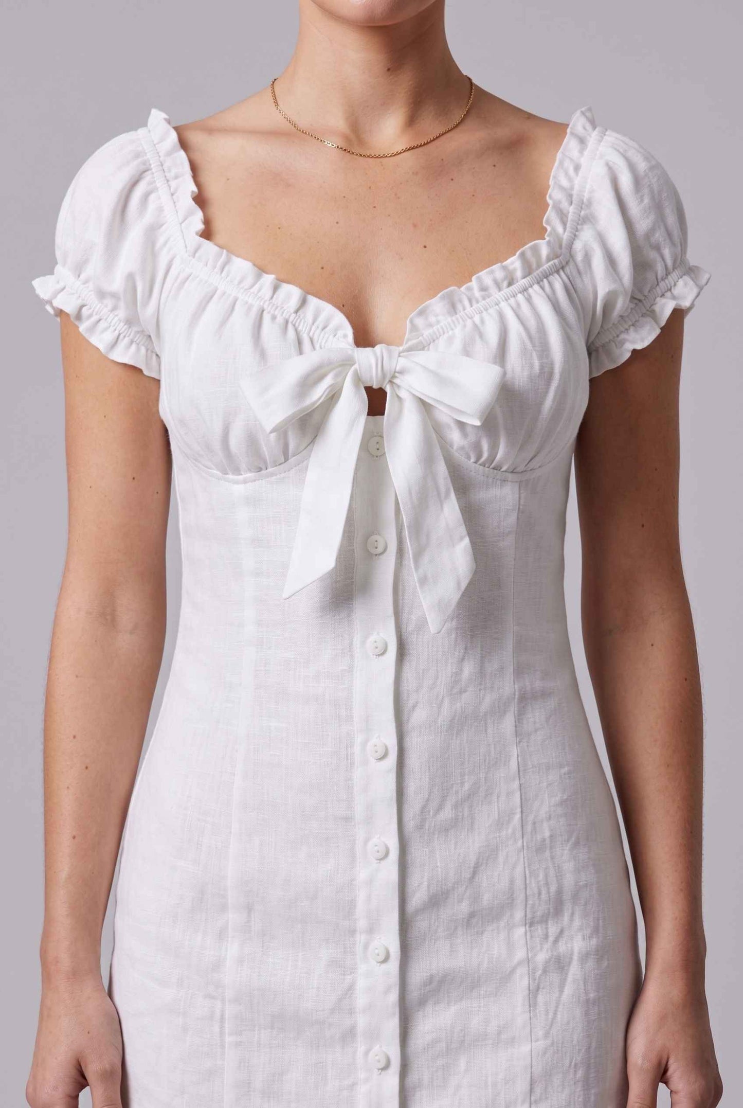Virtual Model wearing The Lily Buttoned Mini Milkmaid Puff Sleeve White Mini Dress