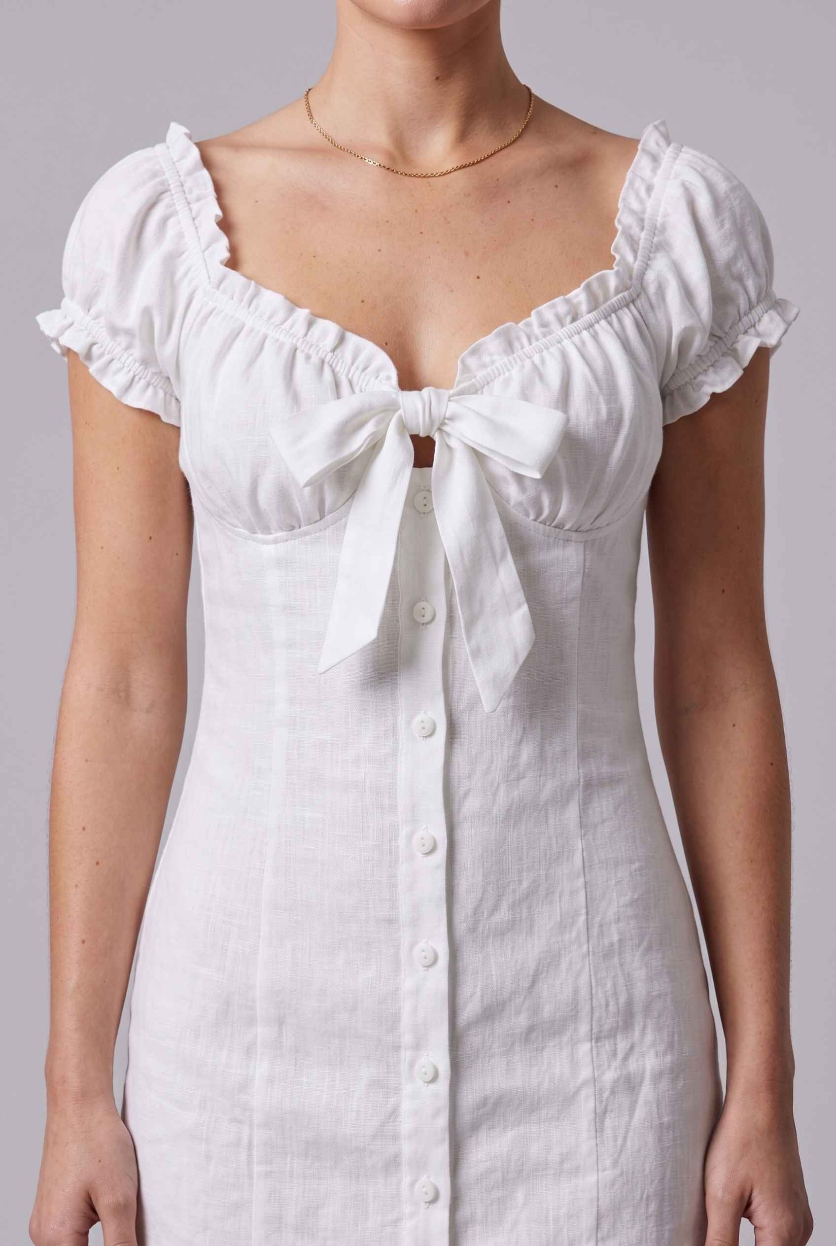 Virtual Model wearing The Lily Buttoned Mini Milkmaid Puff Sleeve White Mini Dress