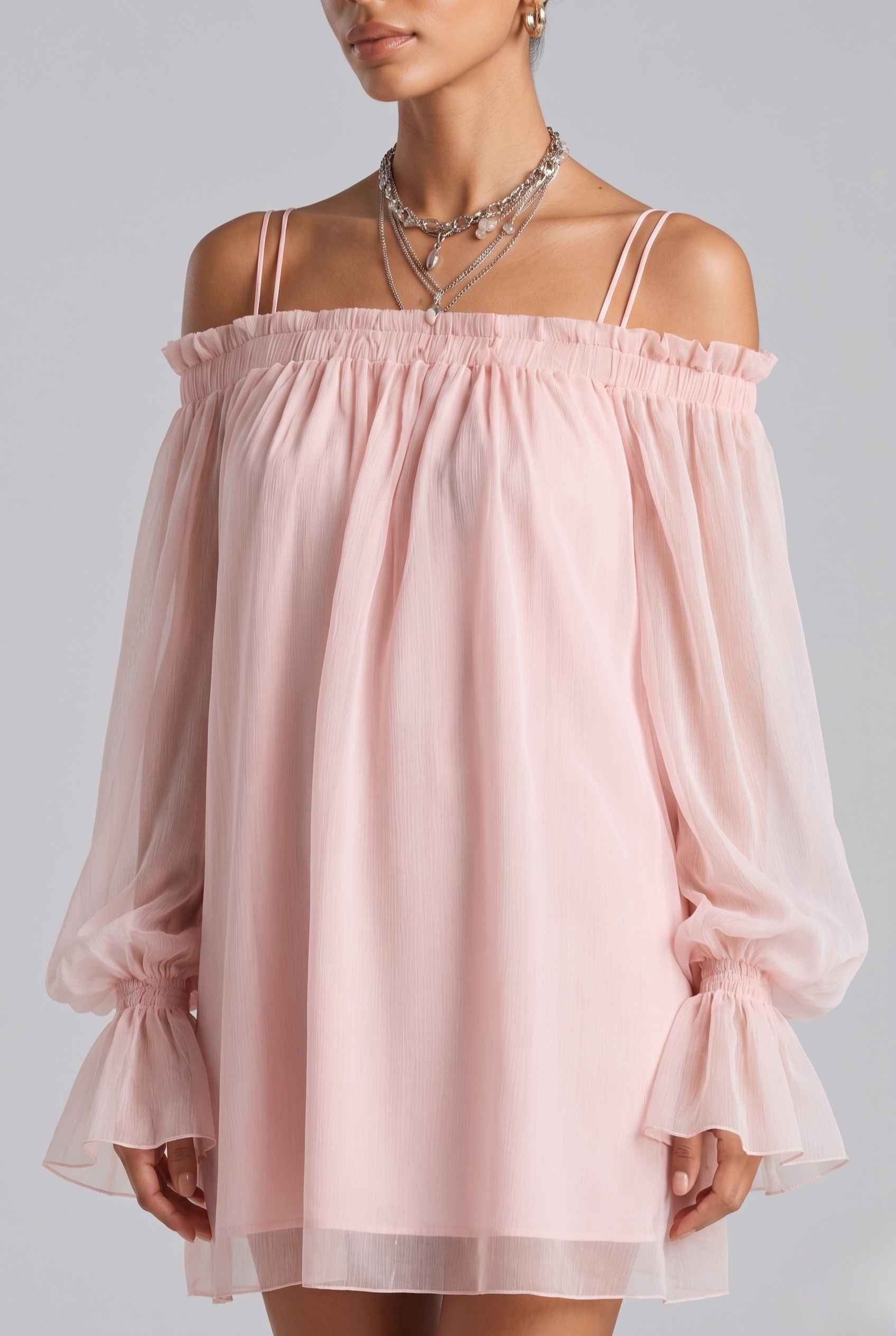 The Lucia Chiffon Dress Off-Shoulder Bishop Sleeve Pink Mini Dress on a plain background