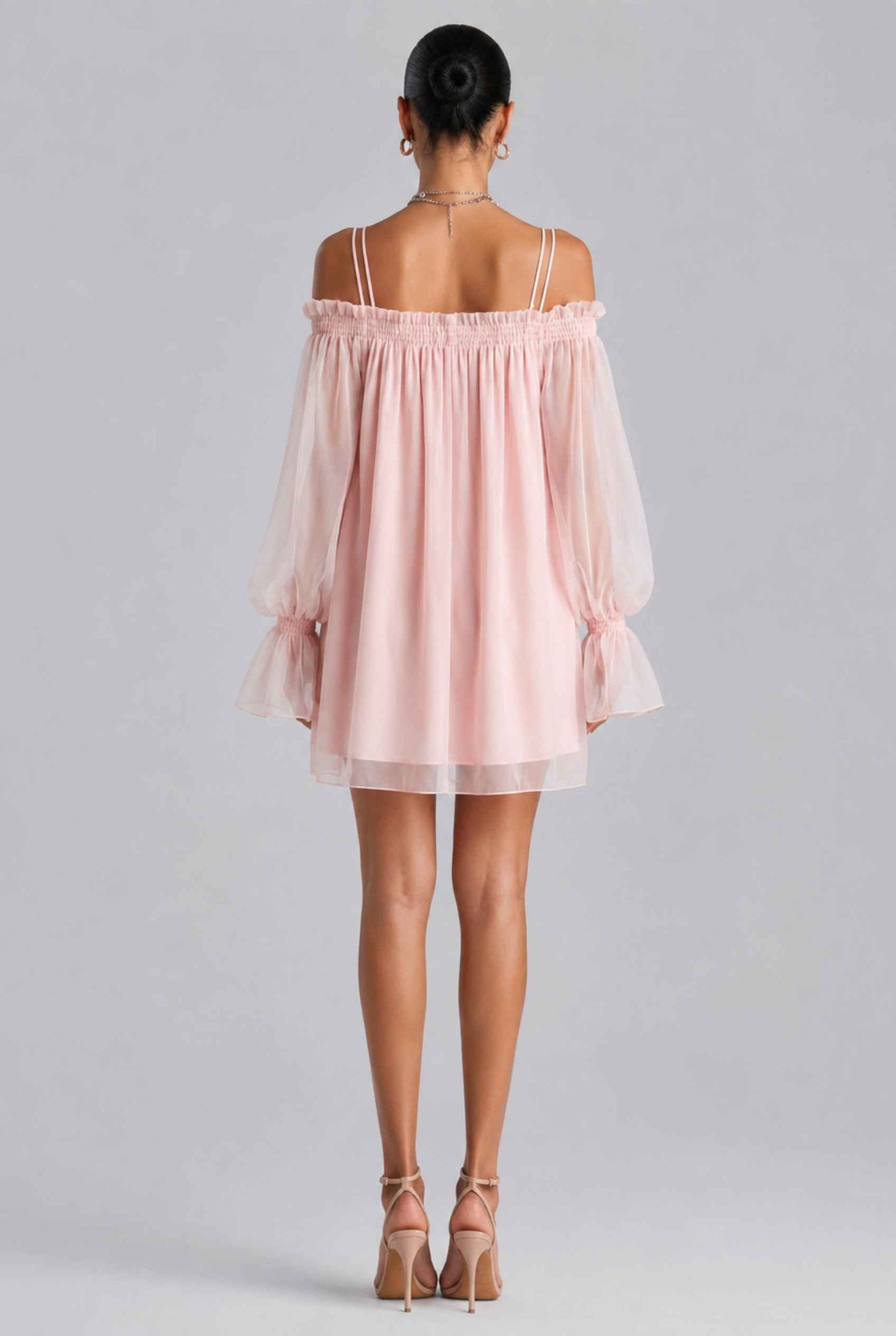 The Lucia Chiffon Dress Off-Shoulder Bishop Sleeve Pink Mini Dress worn by a model on a plain background