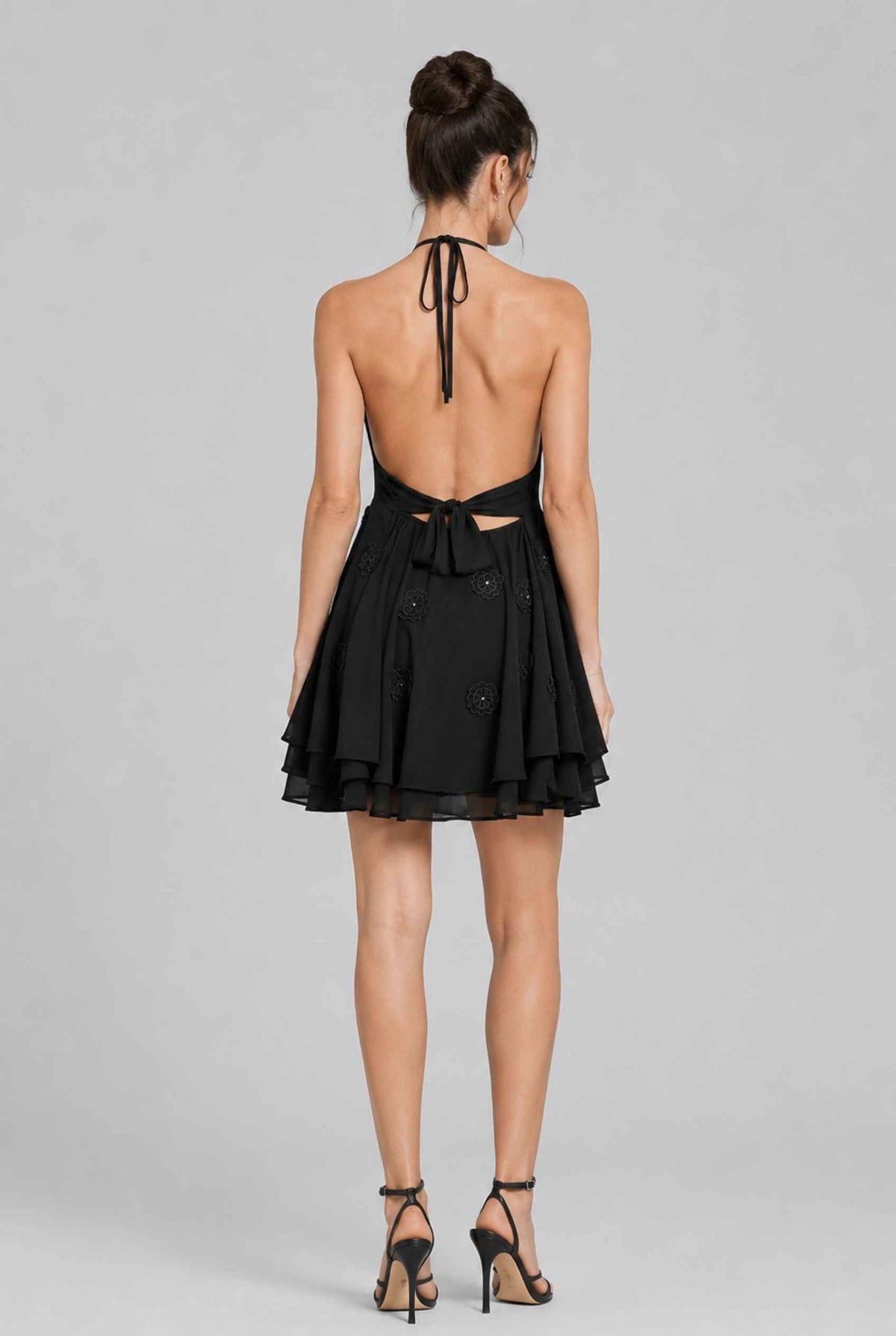 Virtual model wearing The Marbella Chiffon Halter Mini Dress Floral Appliqué Mini Dress in Black