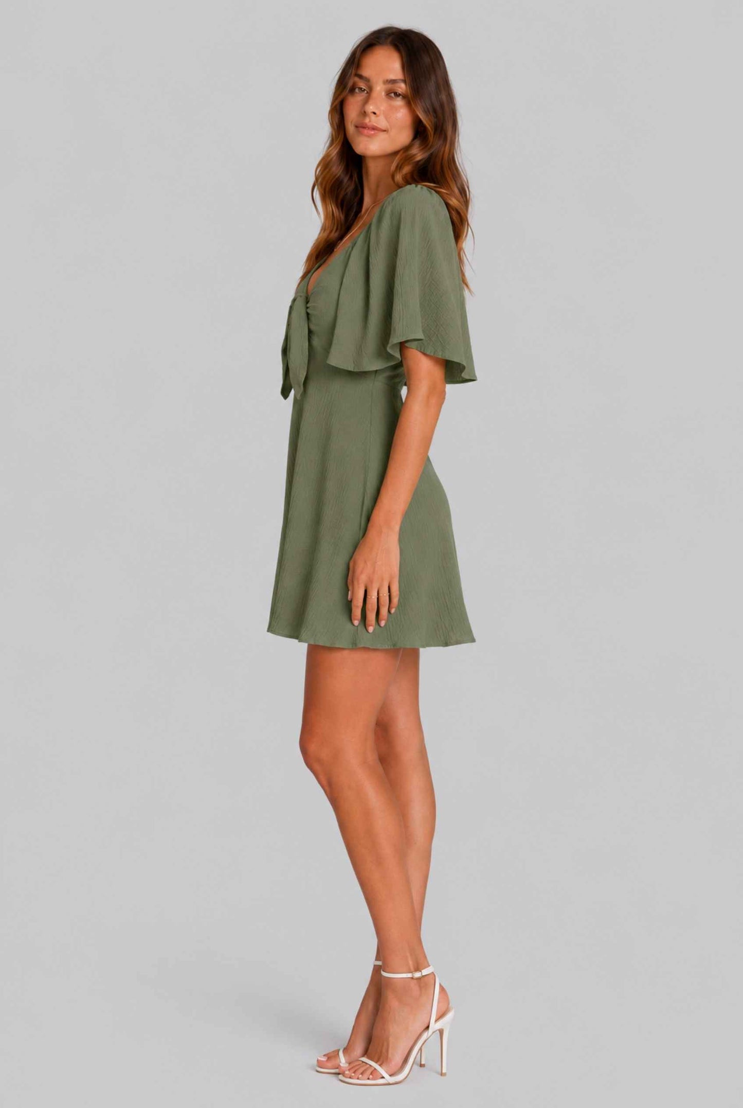 Virtual Model wearing The Melody Flutter Sleeve Mini Tie-Front Flutter-Sleeve Dark Green Mini Dress