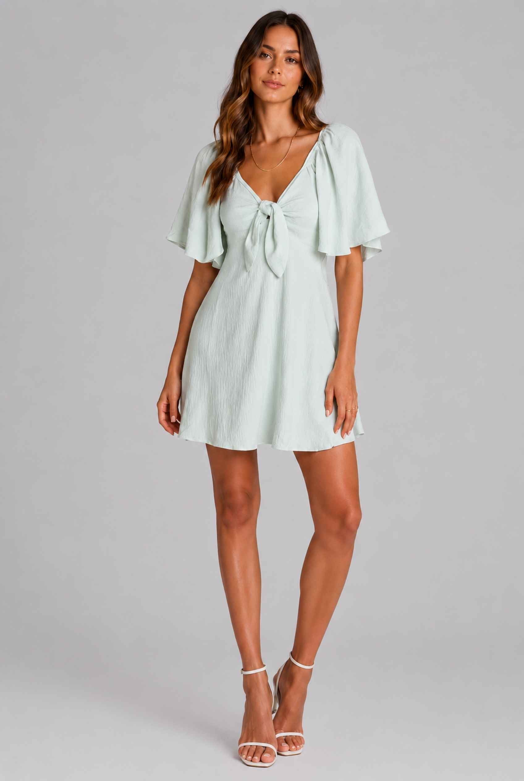 Virtual Model wearing The Melody Flutter Sleeve Mini Tie-Front Flutter-Sleeve Light Green Mini Dress