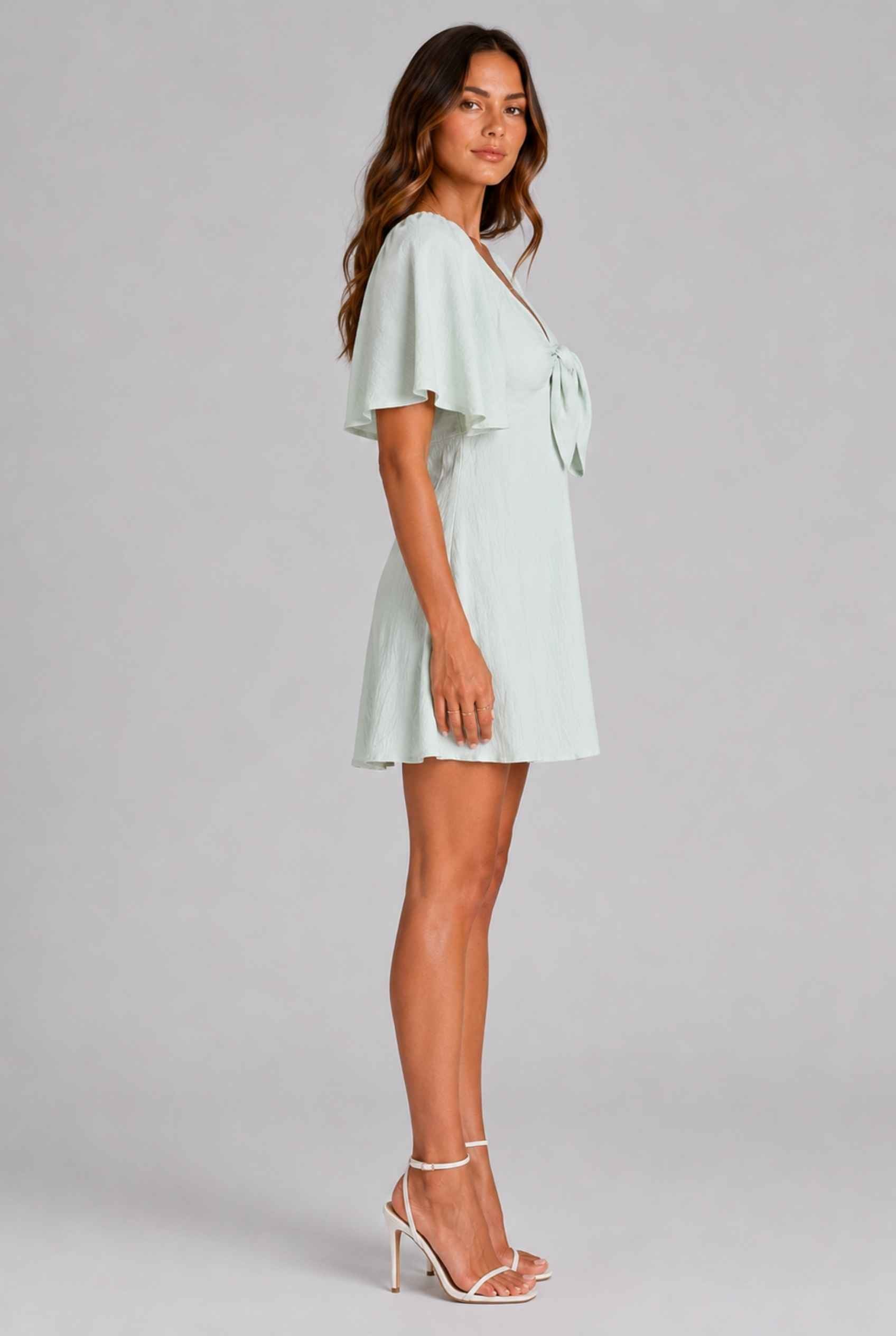 Virtual Model wearing The Melody Flutter Sleeve Mini Tie-Front Flutter-Sleeve Light Green Mini Dress