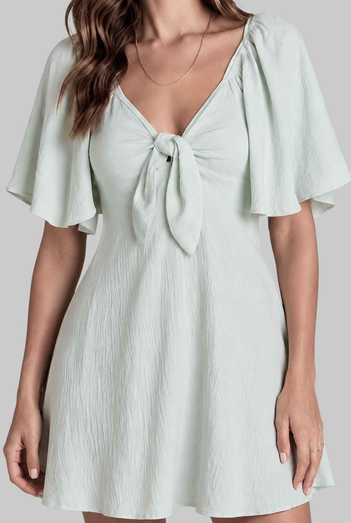 Virtual model wearing The Melody Flutter Sleeve Mini Tie-Front Flutter-Sleeve Mini Dress in Light Green