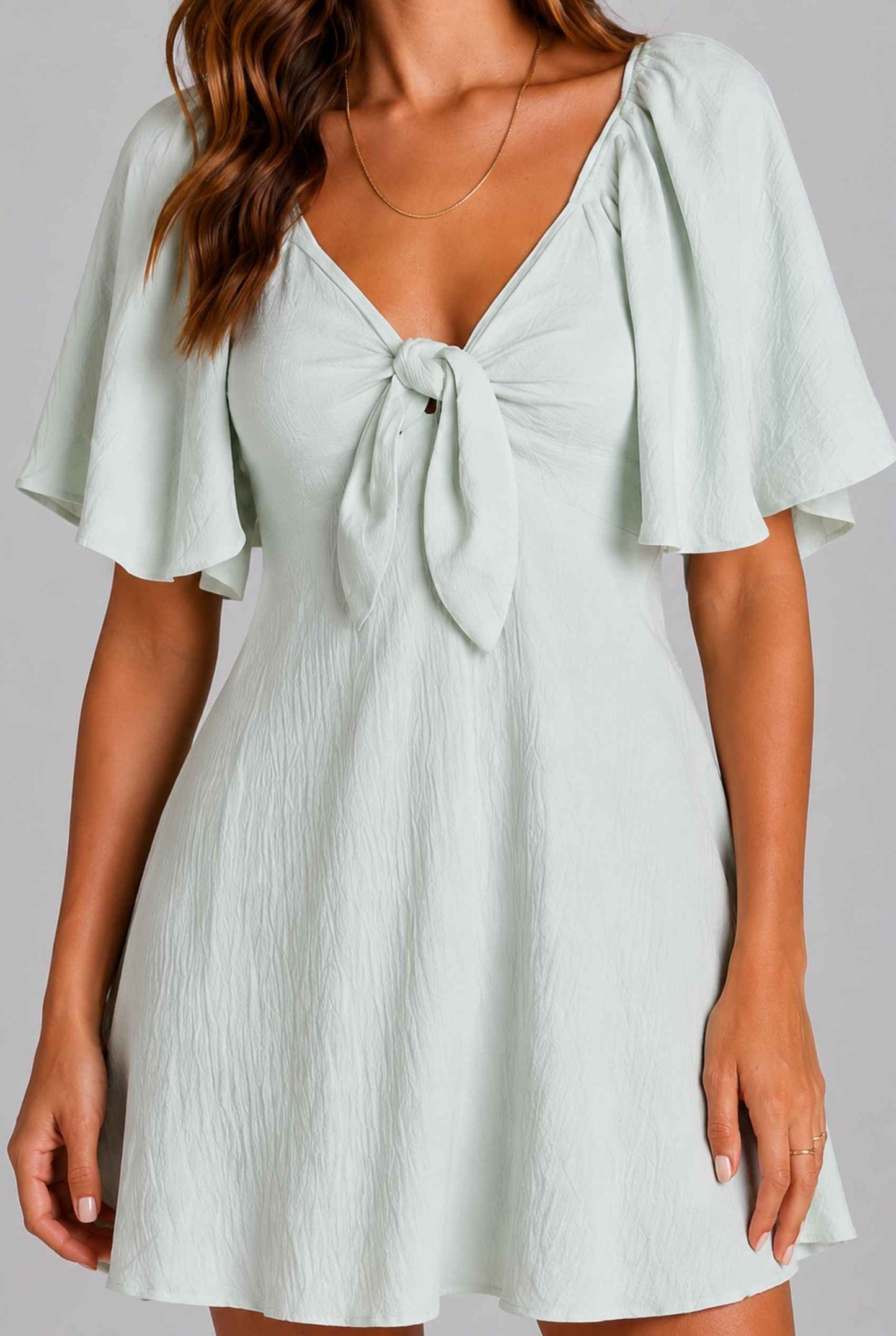 Virtual Model wearing The Melody Flutter Sleeve Mini Tie-Front Flutter-Sleeve Light Green Mini Dress