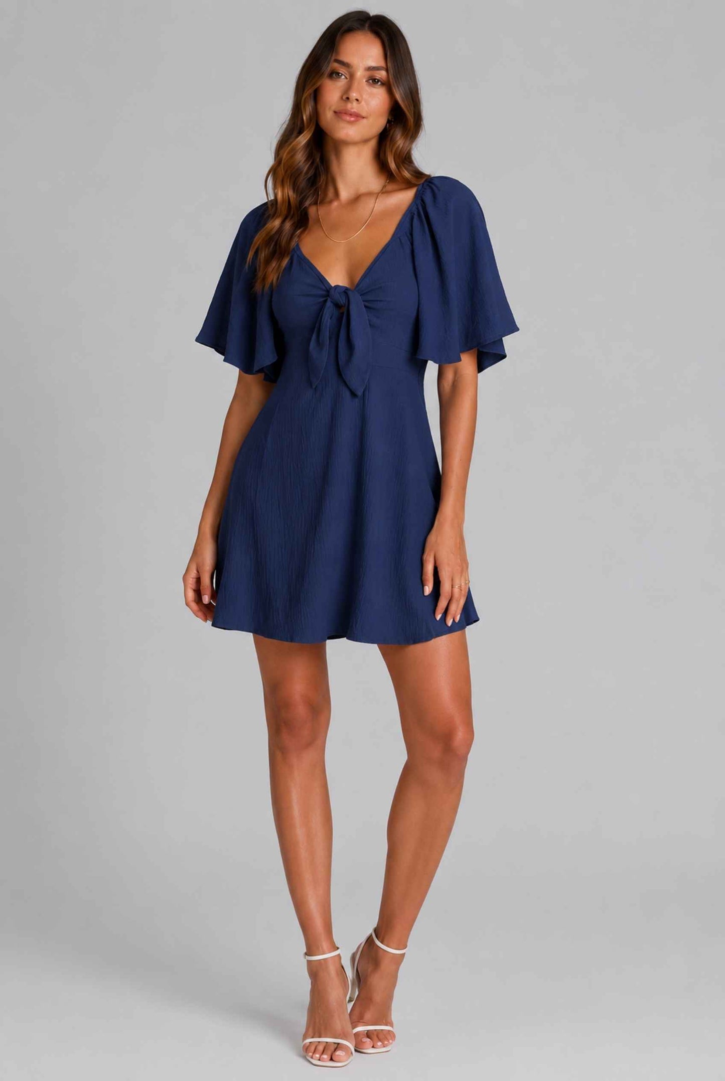 Virtual Model wearing The Melody Flutter Sleeve Mini Tie-Front Flutter-Sleeve Navy Mini Dress