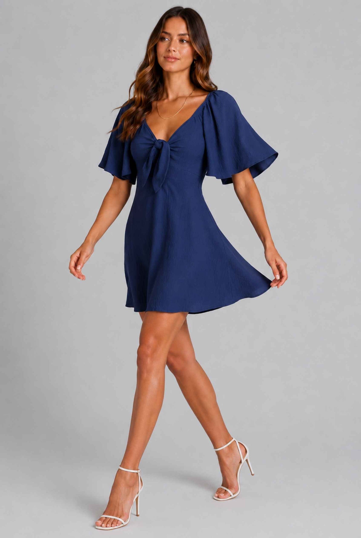 Virtual Model wearing The Melody Flutter Sleeve Mini Tie-Front Flutter-Sleeve Navy Mini Dress