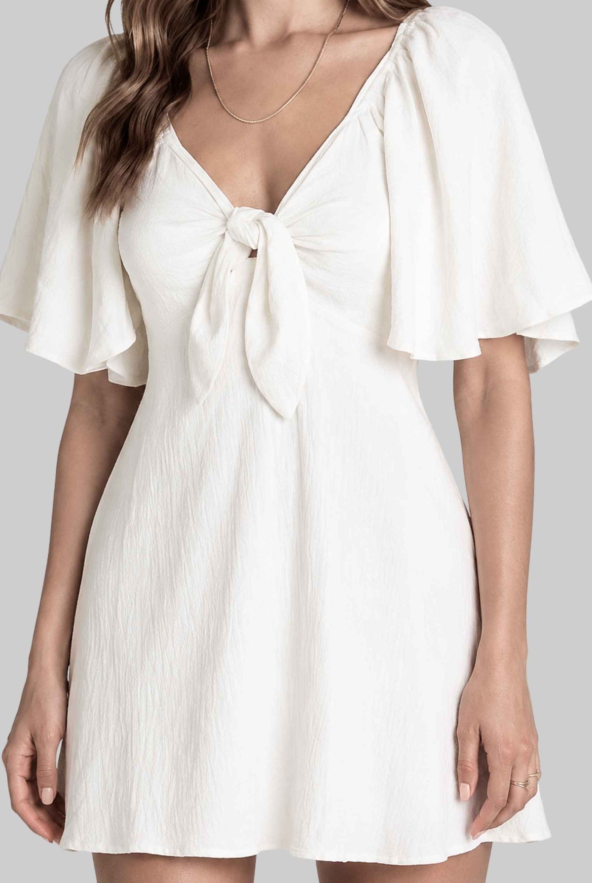 Virtual model wearing The Melody Flutter Sleeve Mini Tie-Front Flutter-Sleeve Mini Dress in White