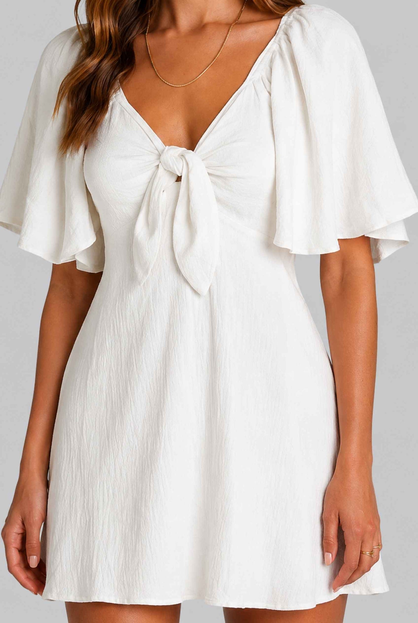 Virtual Model wearing The Melody Flutter Sleeve Mini Tie-Front Flutter-Sleeve White Mini Dress