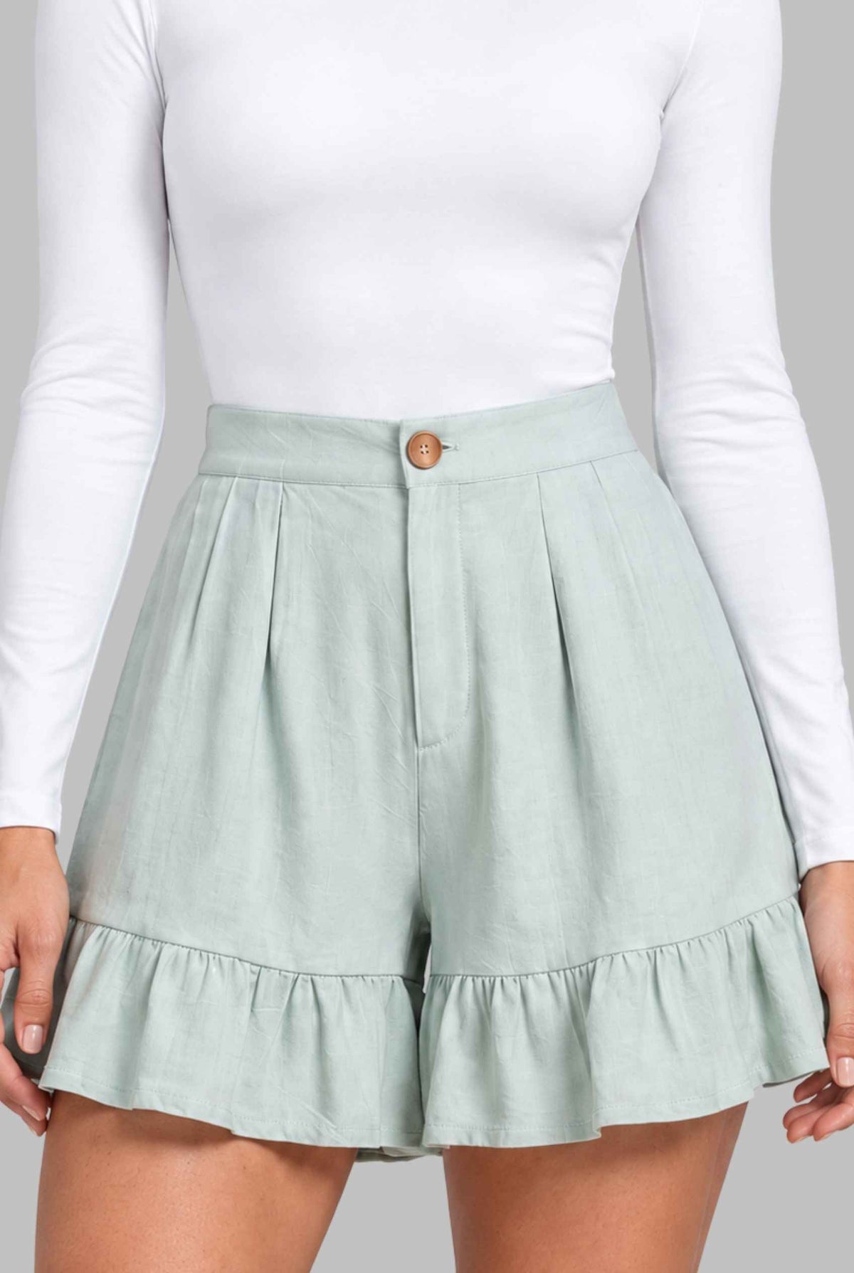 Virtual model wearing The Nerina Ruffle Short High-Waisted Wide-Leg Ruffle Hem Shorts Mint
