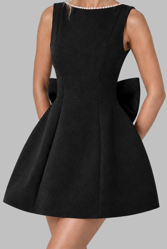 Virtual model wearing  The Noémi Pearl Bow Dress Pearl-Trimmed Statement Bow Mini Dress in Black