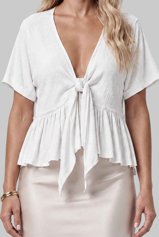 Virtual model wearing The Paloma Tied Peplum Top Cotton Slub Tie-Front Top in White
