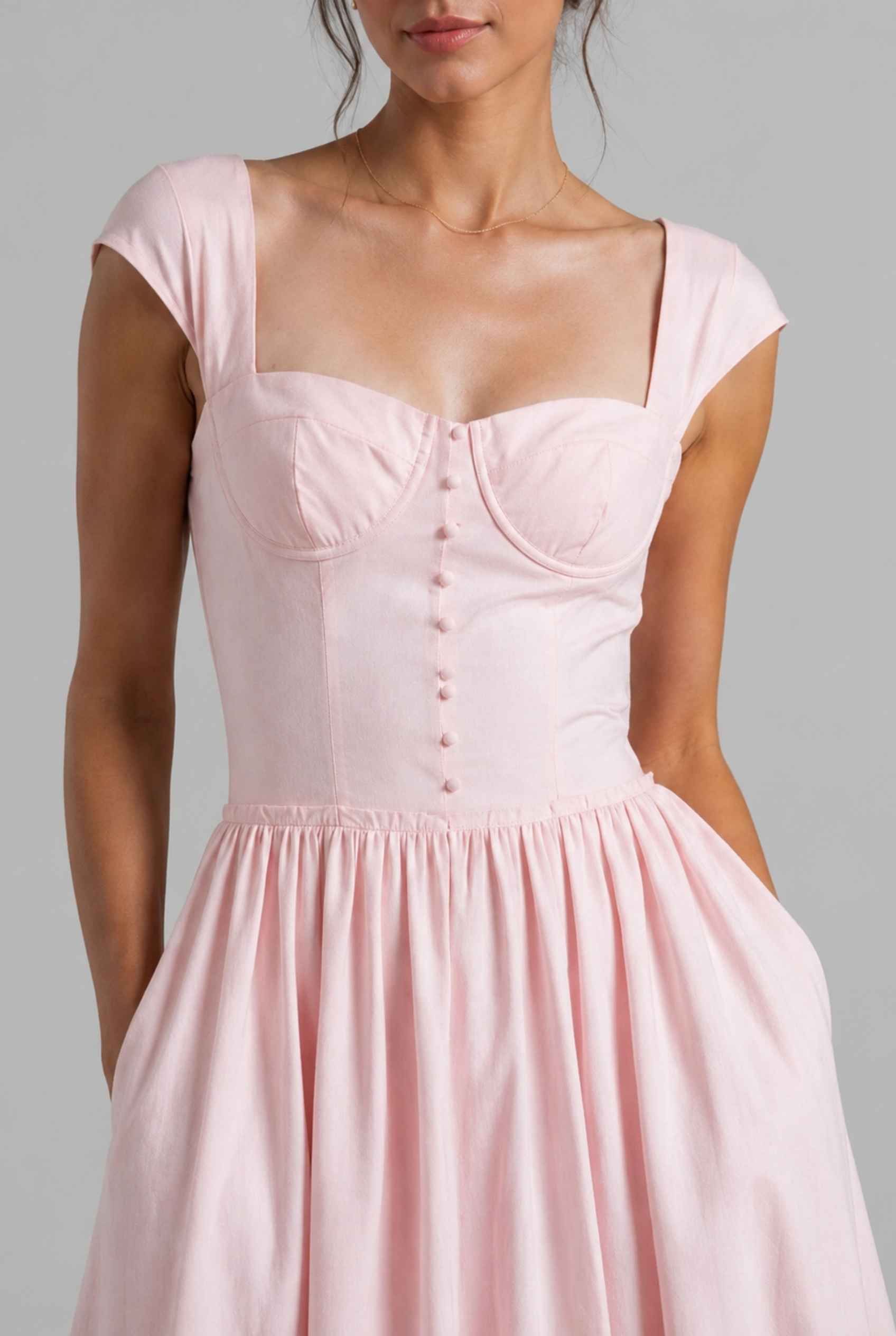The Posie Poplin Midi Bustier Top Pink Poplin Dress on a gray background