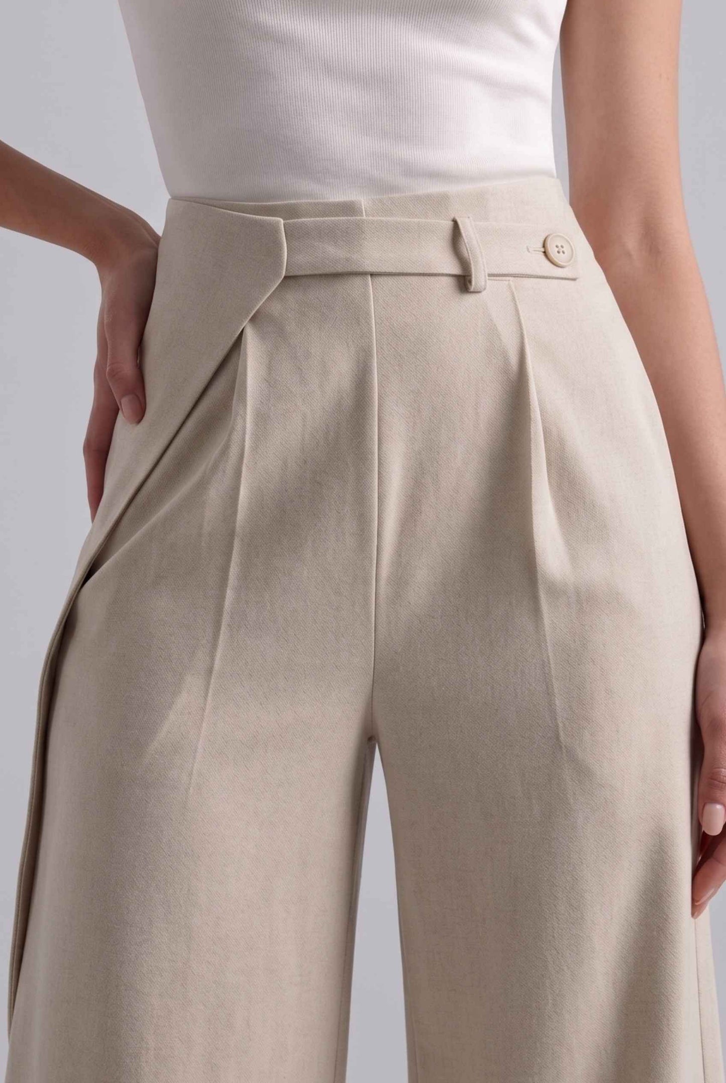 Virtual Model wearing The Rowan Wide-Leg Trouser Asymmetric Beige Pleated Pant