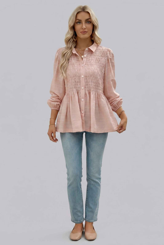 Woman wearing The Sutton Peplum Blouse Smocked Button-Down Blush Pink Top on a gray background