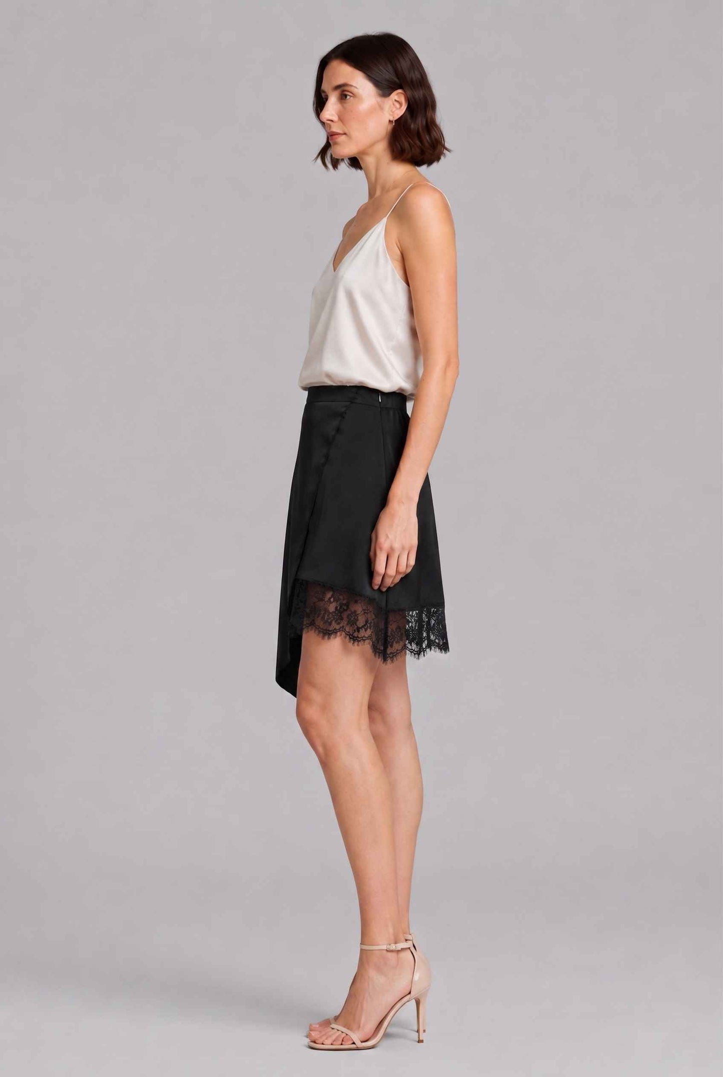 Virtual Model Wearing The Vera Lace Satin Mini Skirt Asymmetrical Lace Trim Black Wrap Skirt