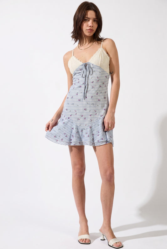 Model wearing Valencia Lace-Trim Gingham Mini Dress Floral Slip Dress in Blue with minimalist heeled sandals