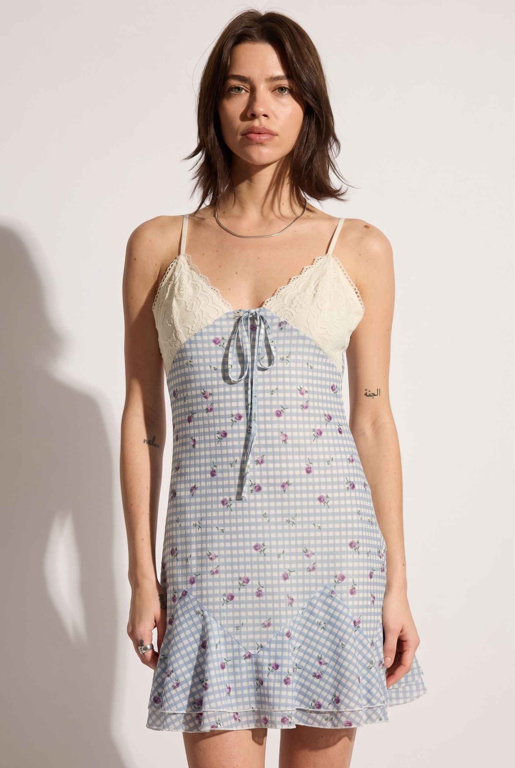 Model wearing Valencia Lace-Trim Gingham Mini Dress Floral Slip Dress in Blue close up lace and tied detail