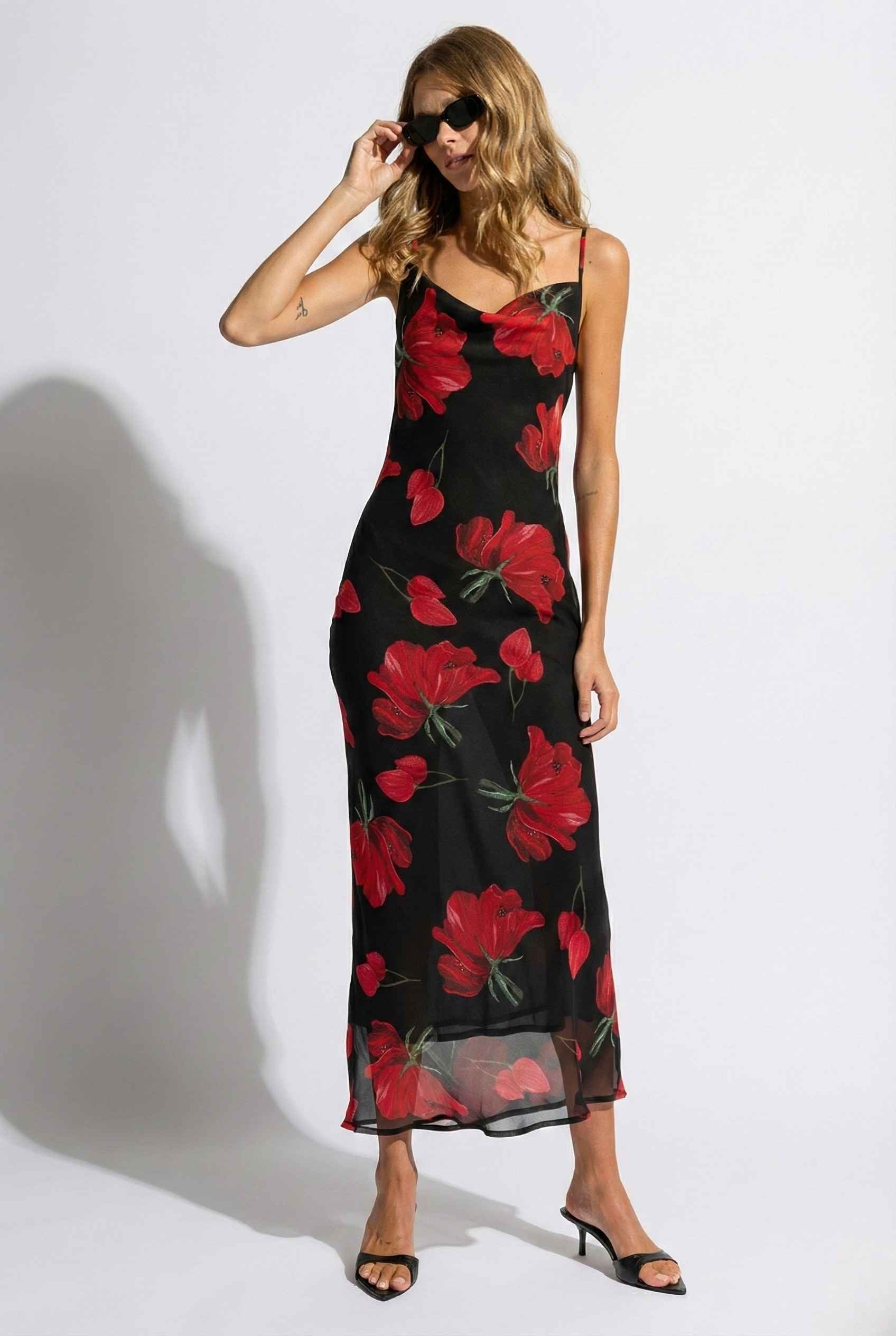 Woman wearing a Valentina Maxi Black Cowl Neck Floral Mesh Dress with red floral pattern against a white background