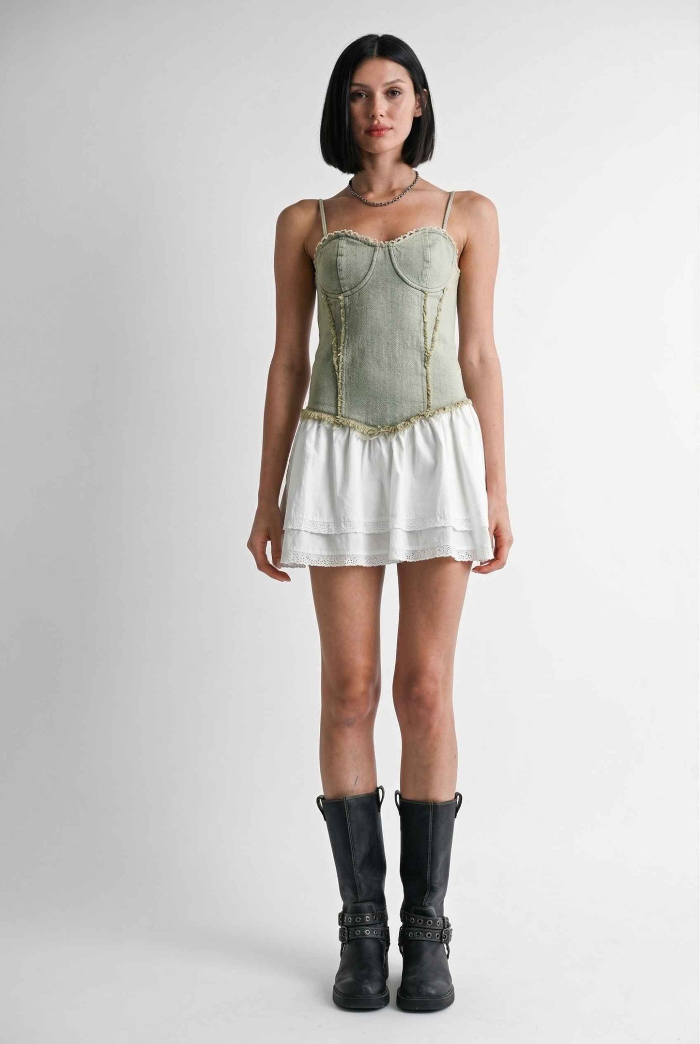 Model wearing Willow Mini in Light Green Denim with cotton tiers dress paired with combat boots