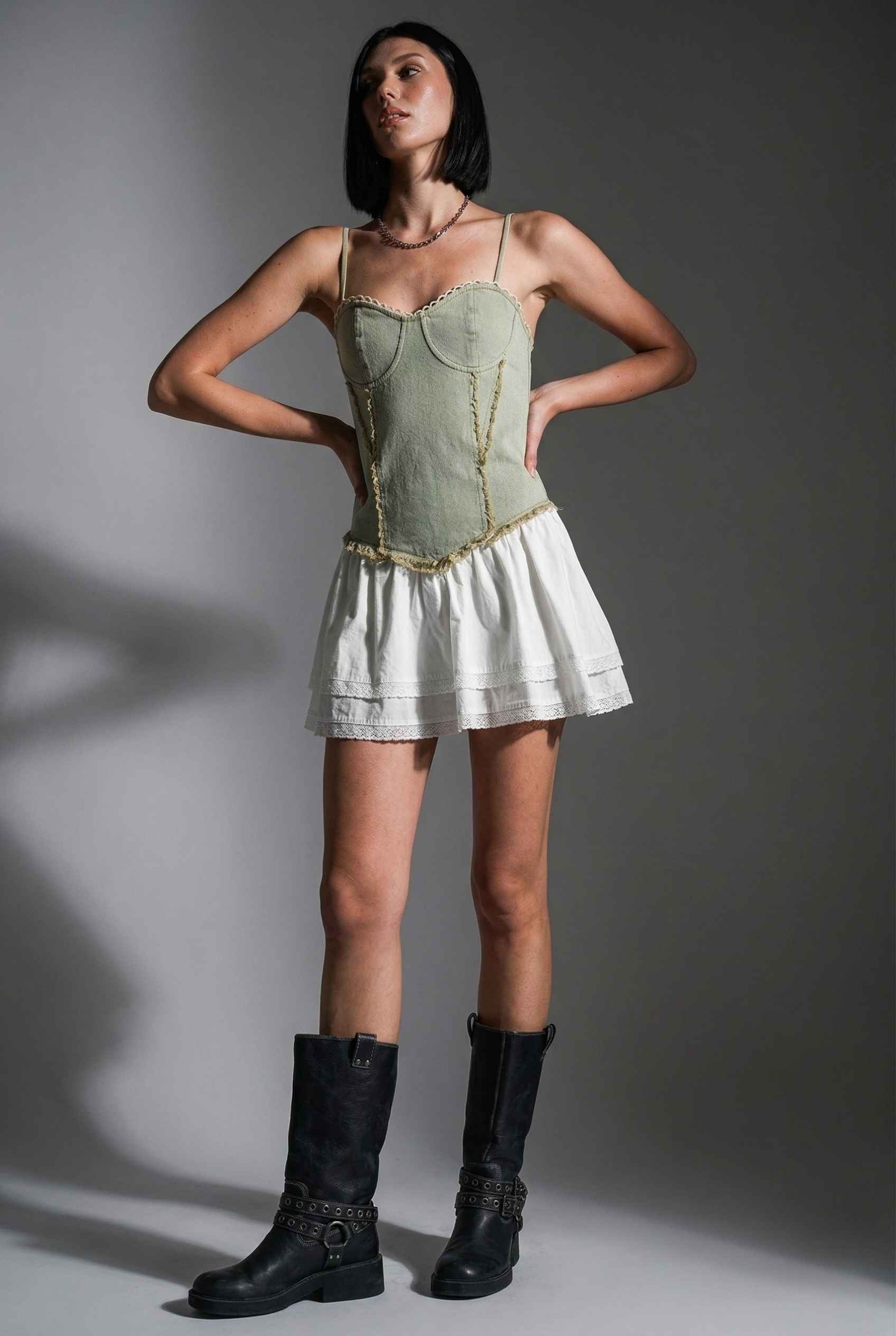 Model wearing Willow Mini in Light Green Denim with cotton tiers dress paired with combat boots