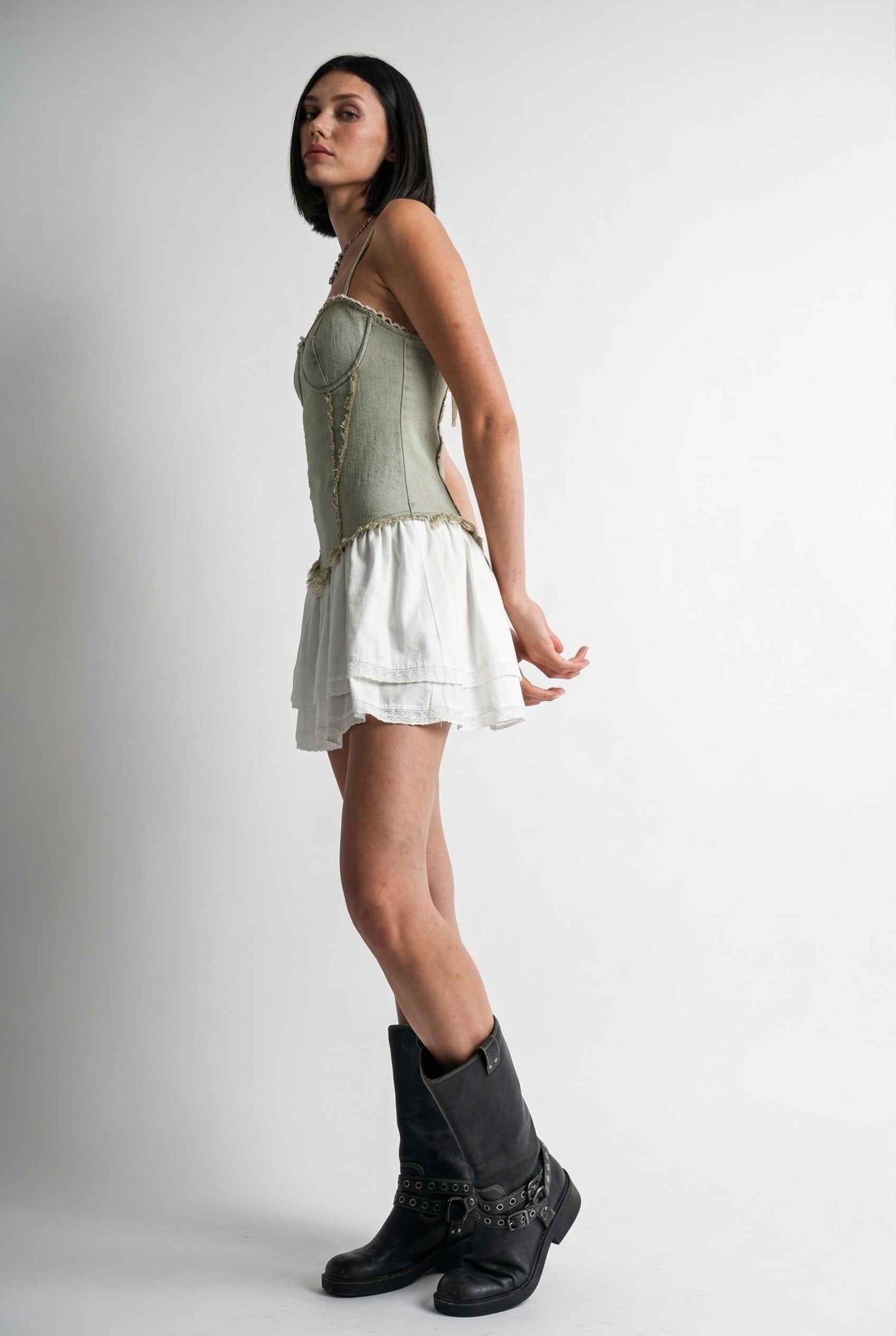 Model wearing Willow Mini in Light Green Denim with cotton tiers dress paired with combat boots