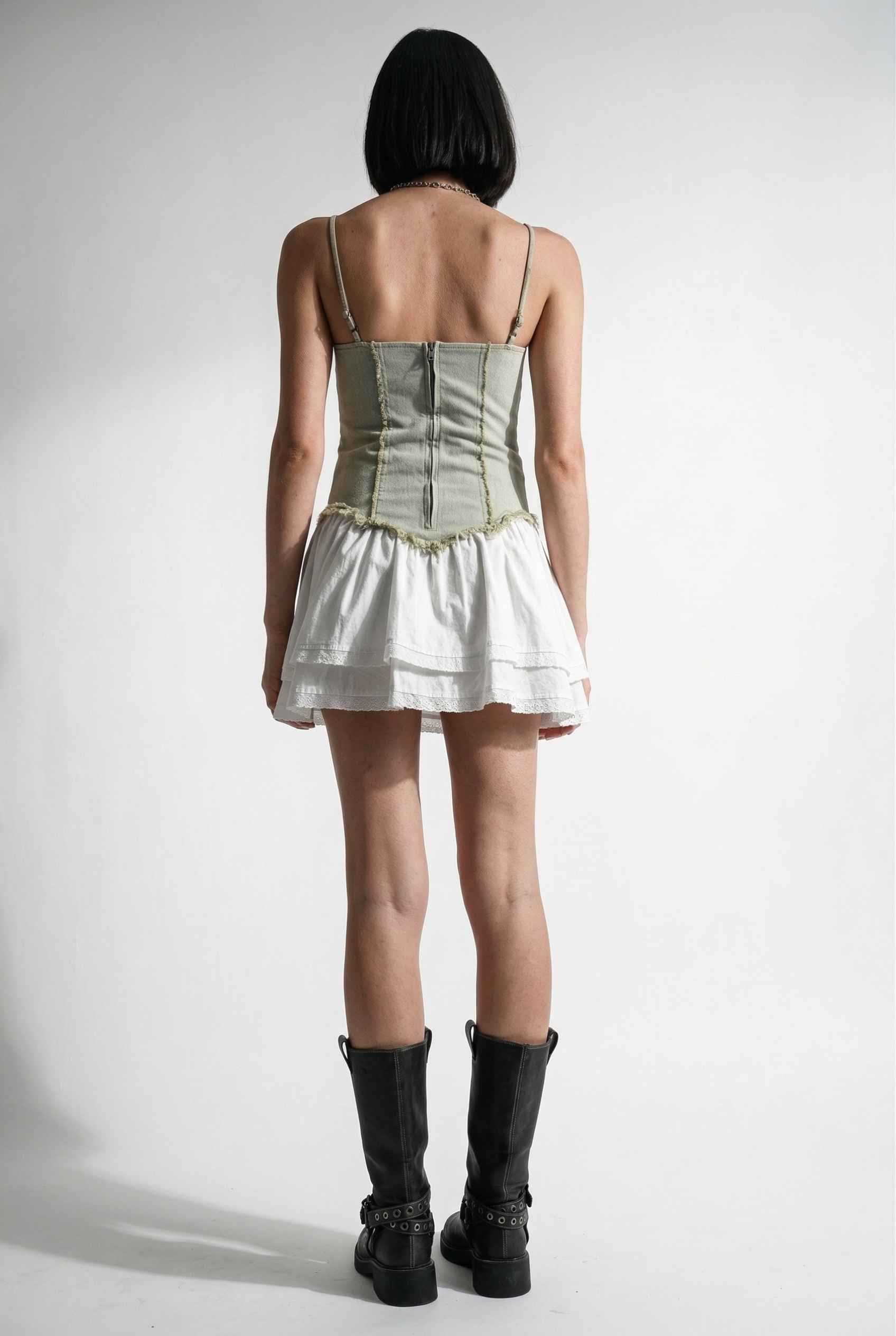 Model wearing Willow Mini in Light Green Denim with cotton tiers dress paired with combat boots