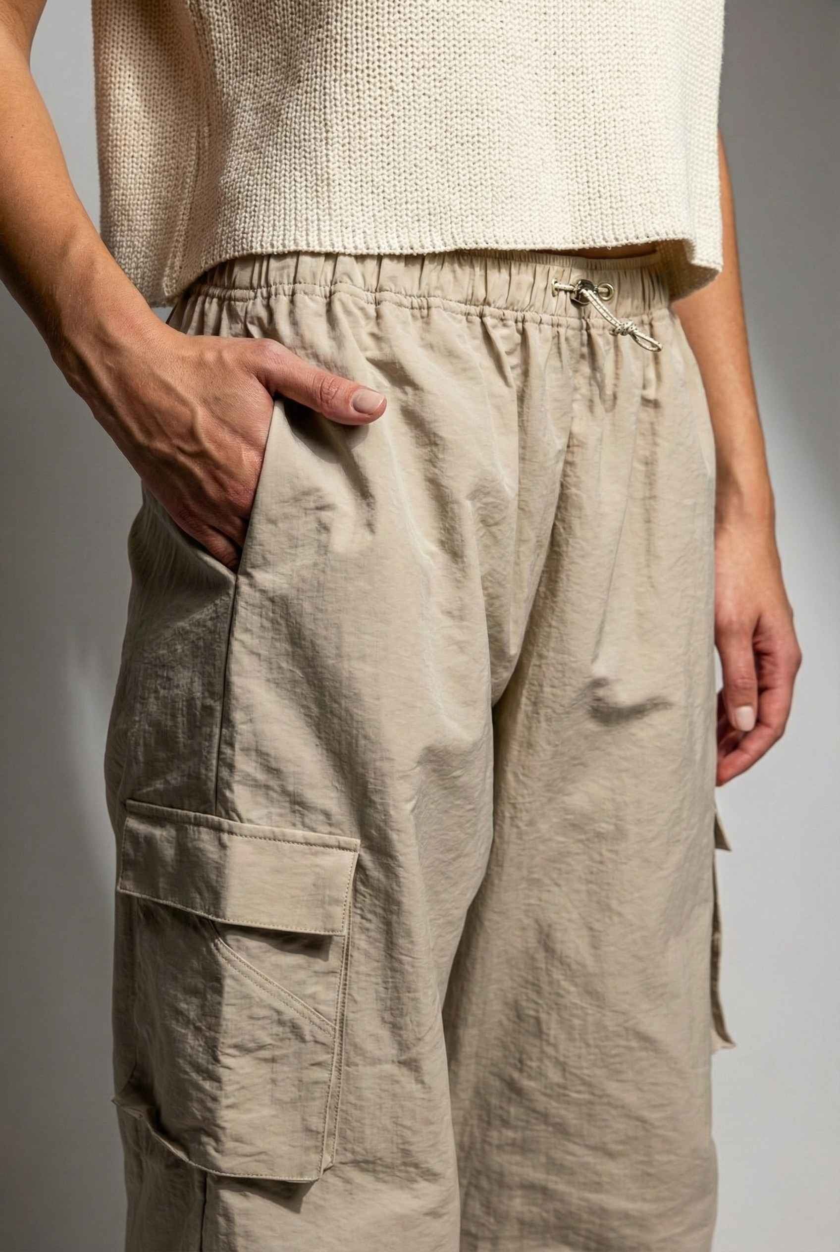 Model wearing Wren Pants 100% Nylon Parachute Cargo Pants in Taupe with t-shirt